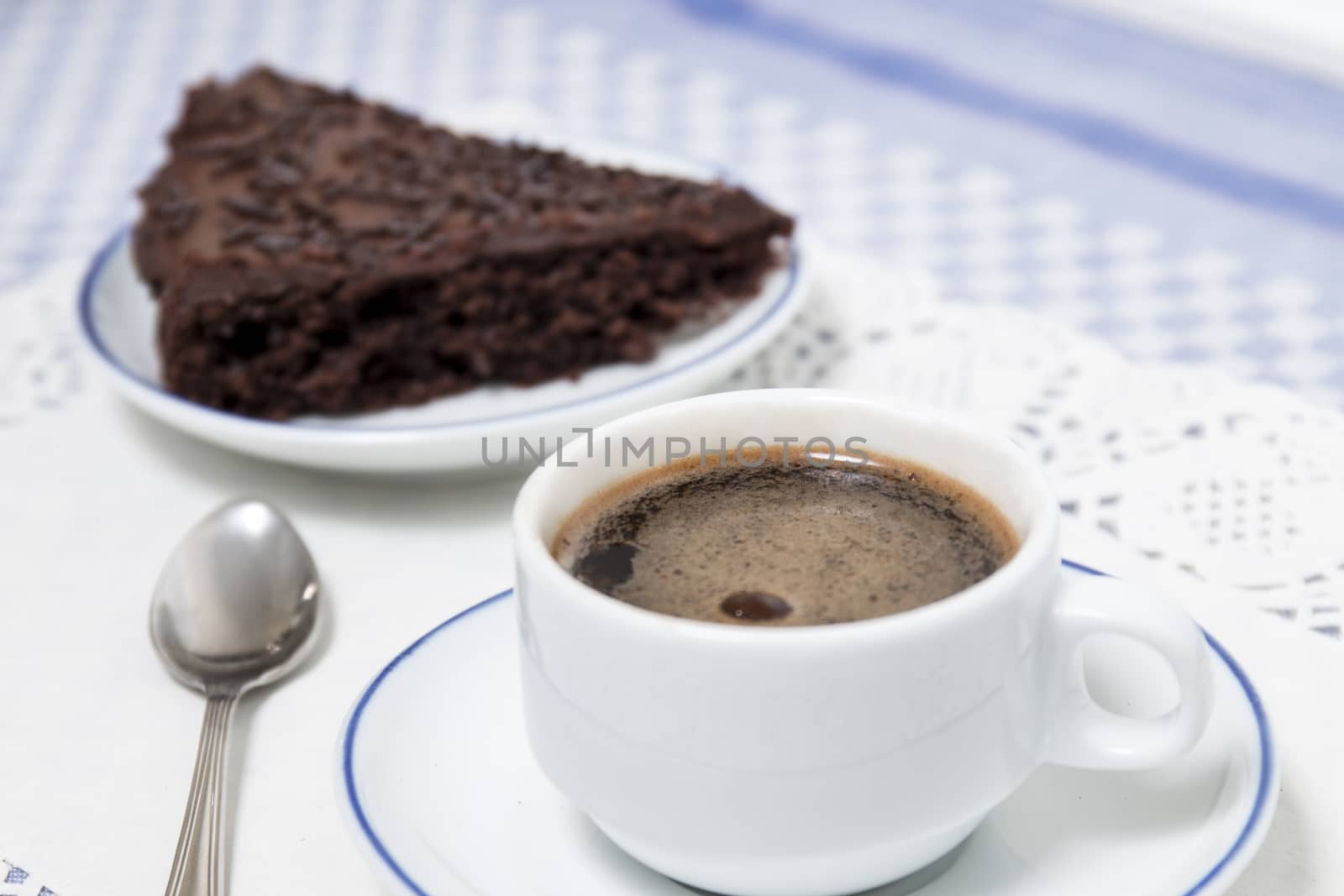Composition of the classic coffee cup espresso with a piece of brigadeiro cake.