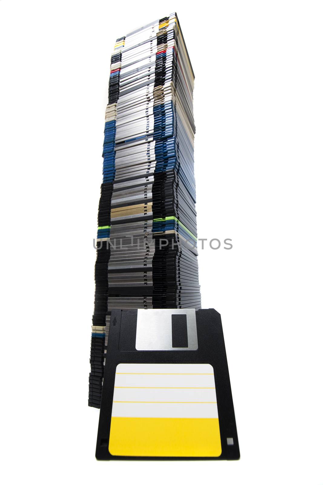 Vertical pile of computer floppy disks isolated on a white background.