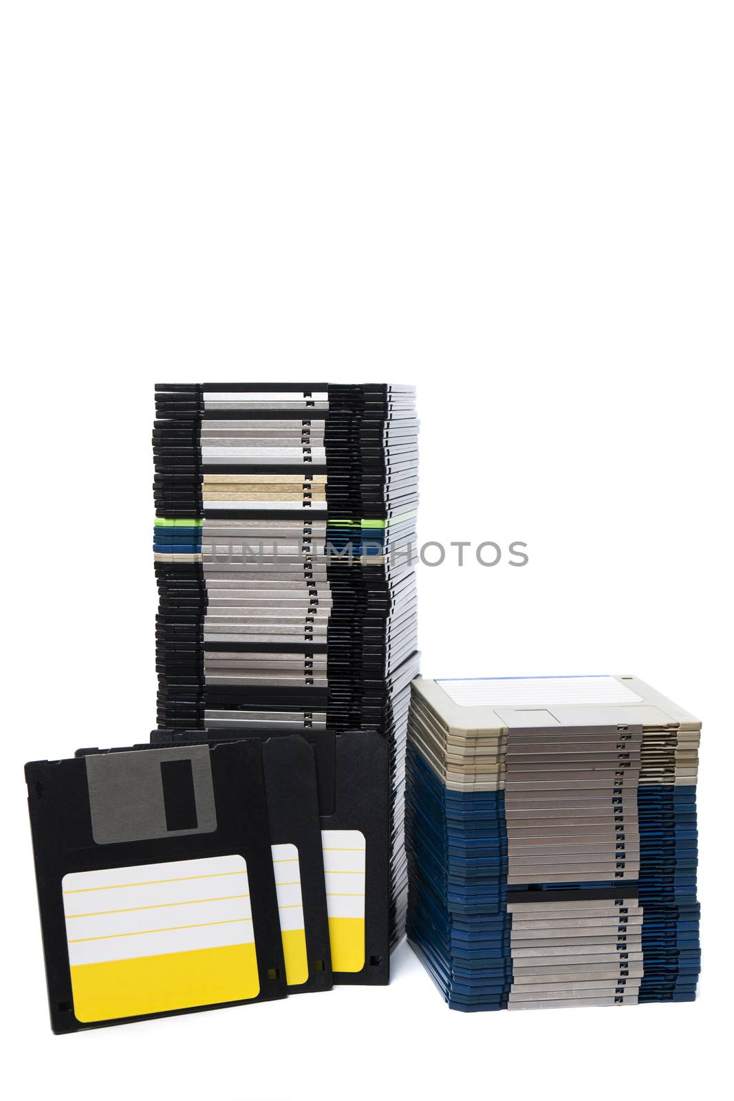 Vertical pile of computer floppy disks isolated on a white background.