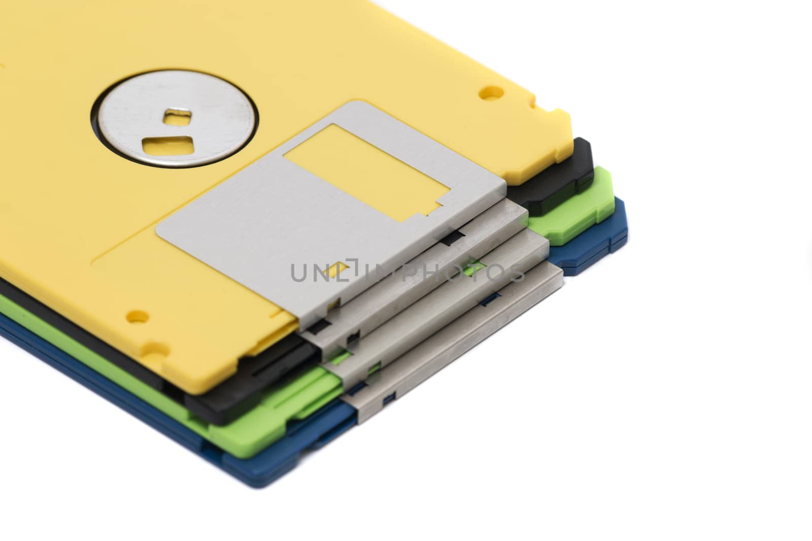 Pile of colorful computer floppy disks isolated on a white background.