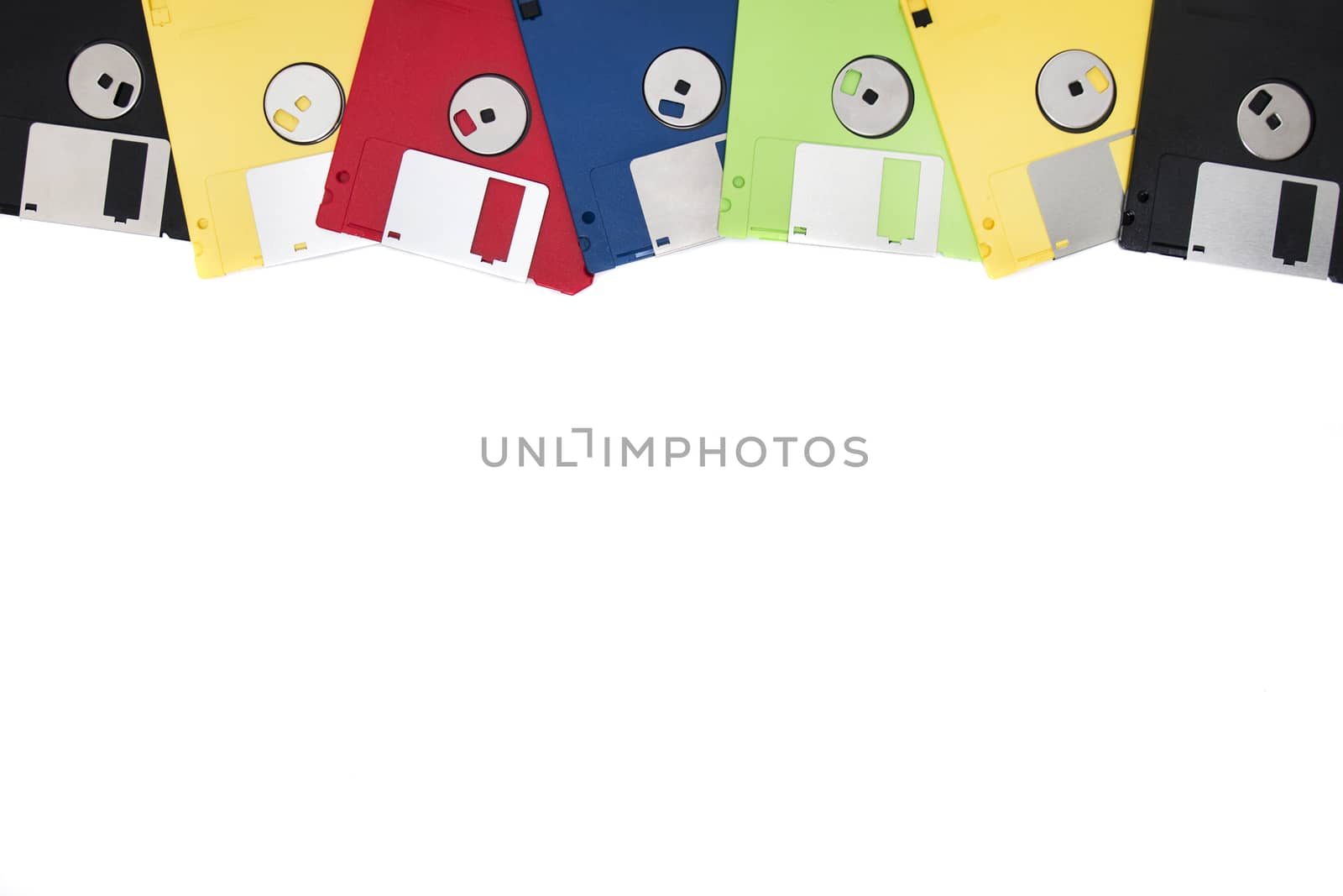 row of colorful computer floppy disks isolated on a white background.