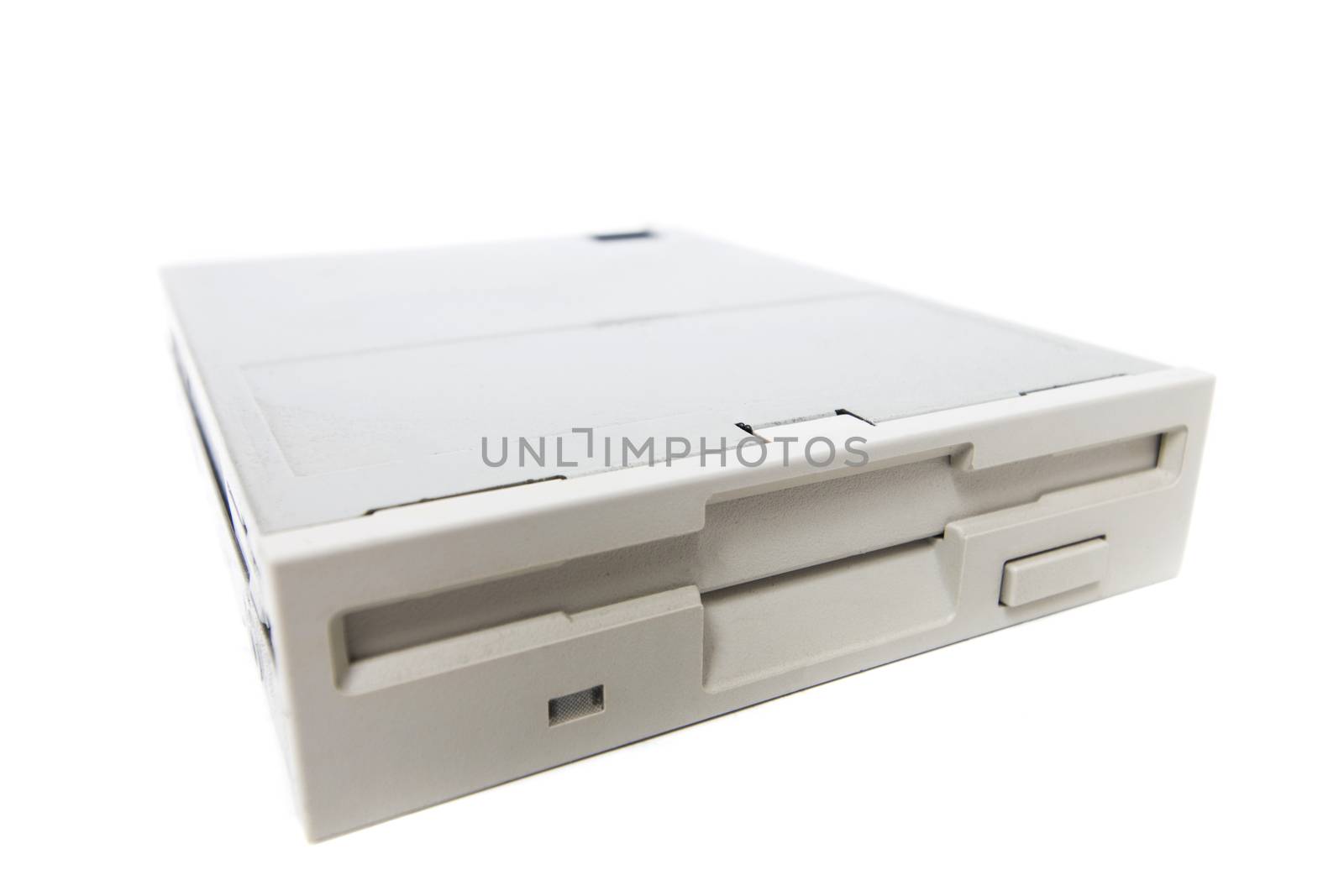 Closeup view of a computer floppy drive, isolated on a white background.