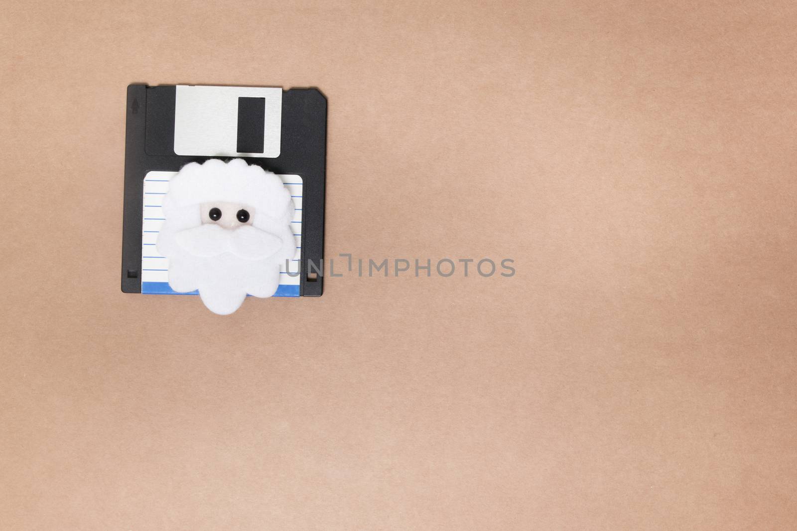 old floppy disk concept isolated on a brown background.
