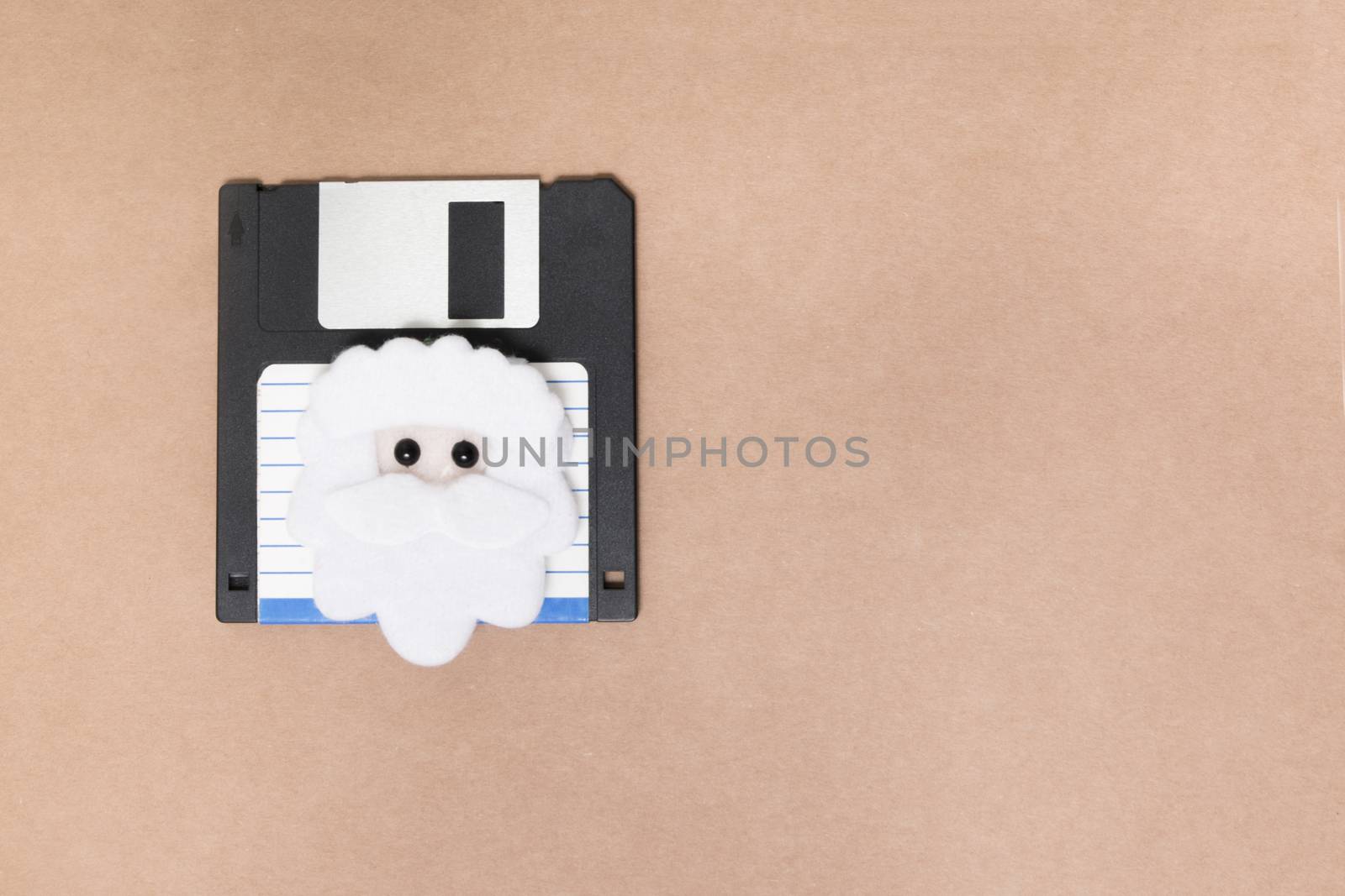 old floppy disk concept isolated on a brown background.