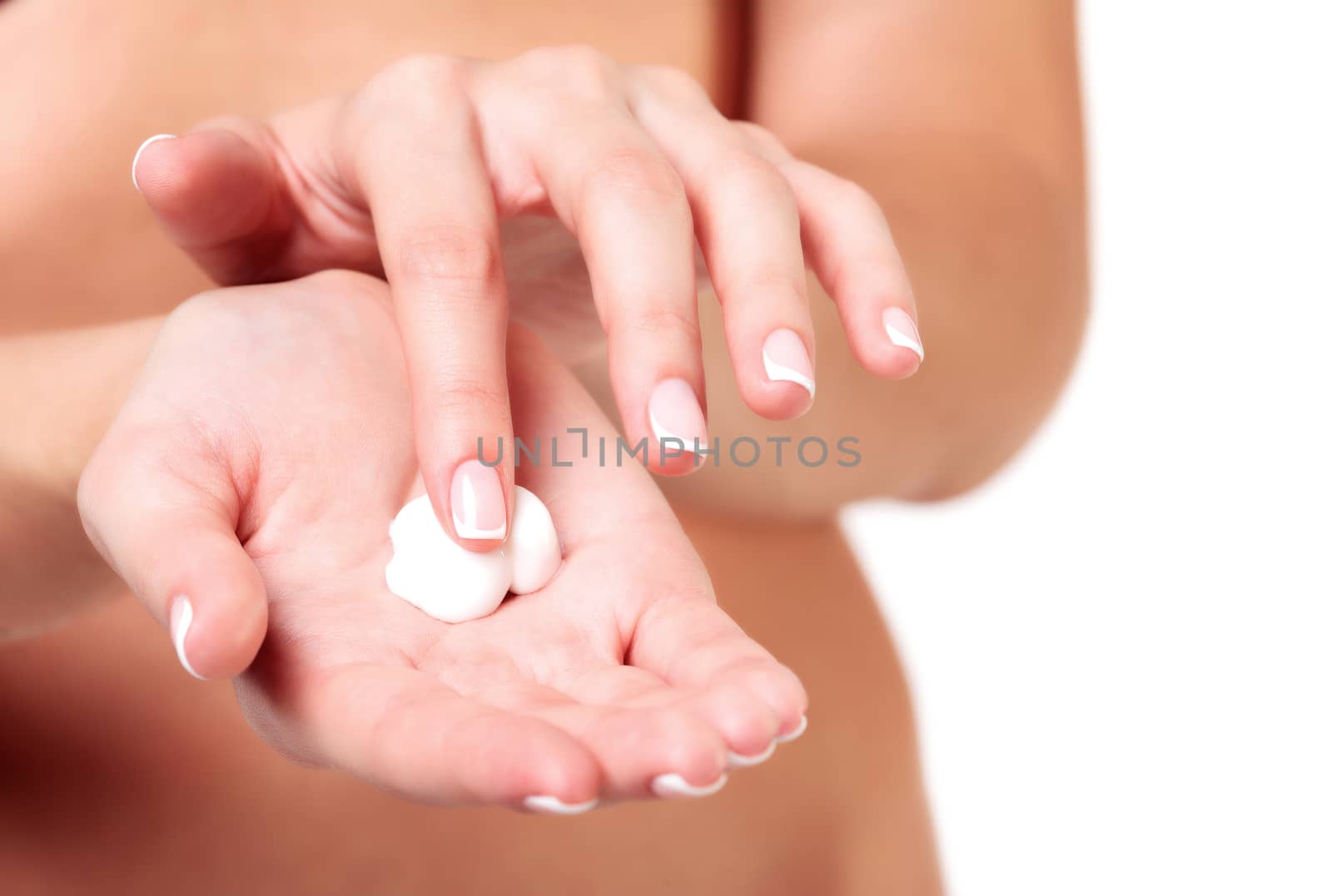 Closeup shot of beautiful woman's hands with cream, isolated on by Nobilior