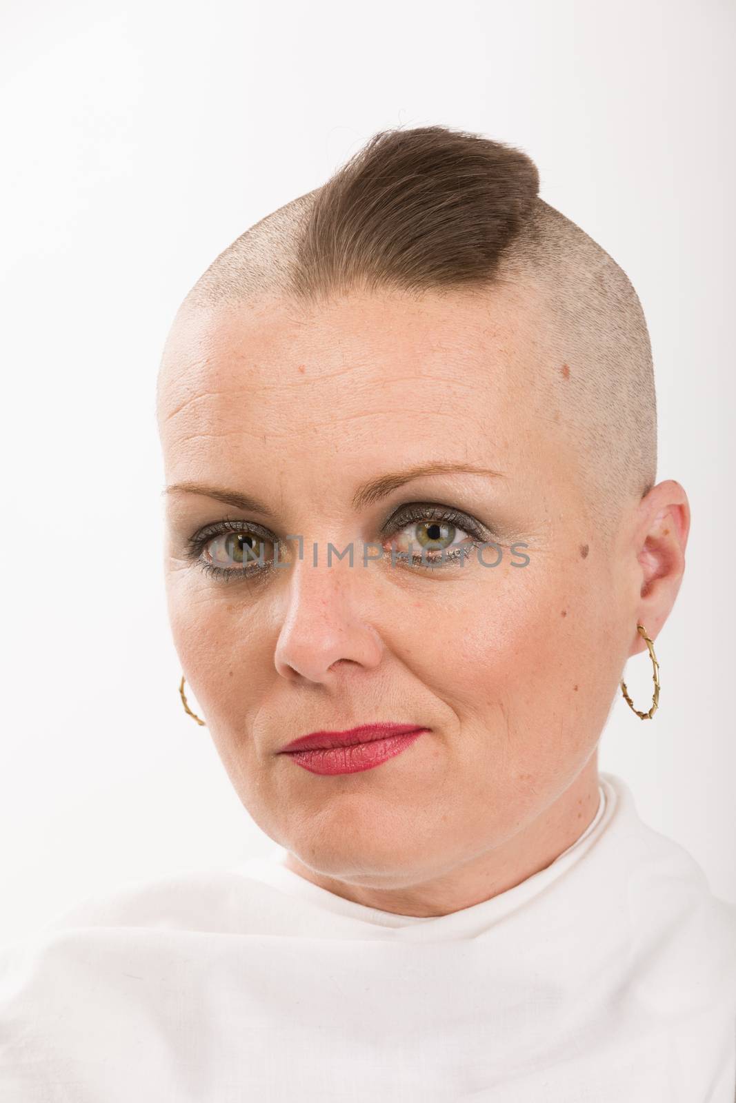 Portrait of beautiful middle age woman patient with cancer with partially shaved head like punk, hope in healing. She lost her hair