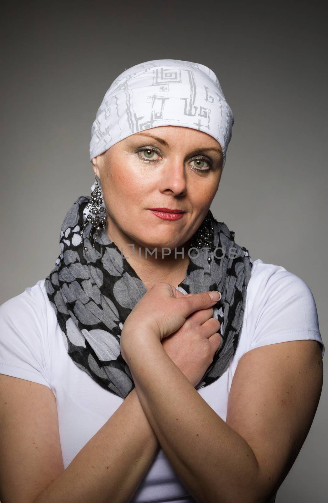 Portrait of beautiful middle age woman patient with cancer wearing headscarf, hope in healing