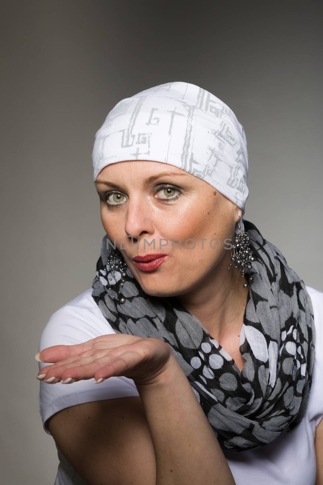 Portrait of beautiful positive smiling middle age woman patient with cancer wearing headscarf, hope in healing
