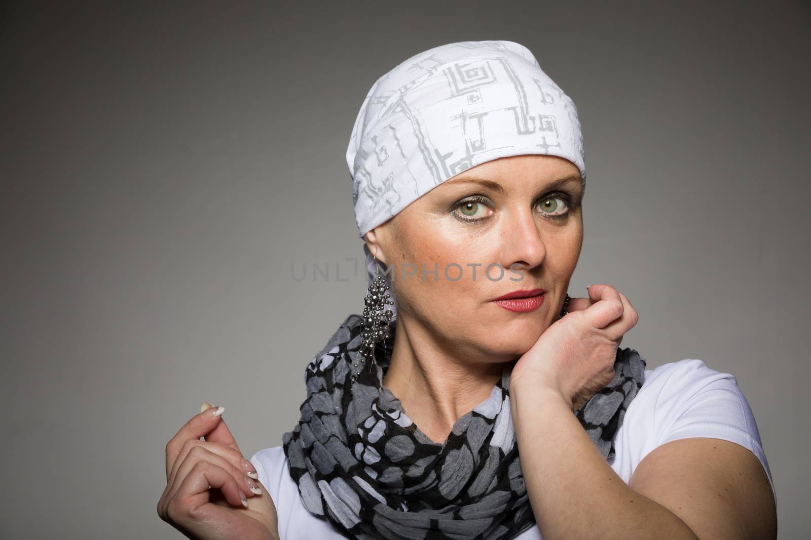 Portrait of beautiful middle age woman patient with cancer wearing headscarf, hope in healing
