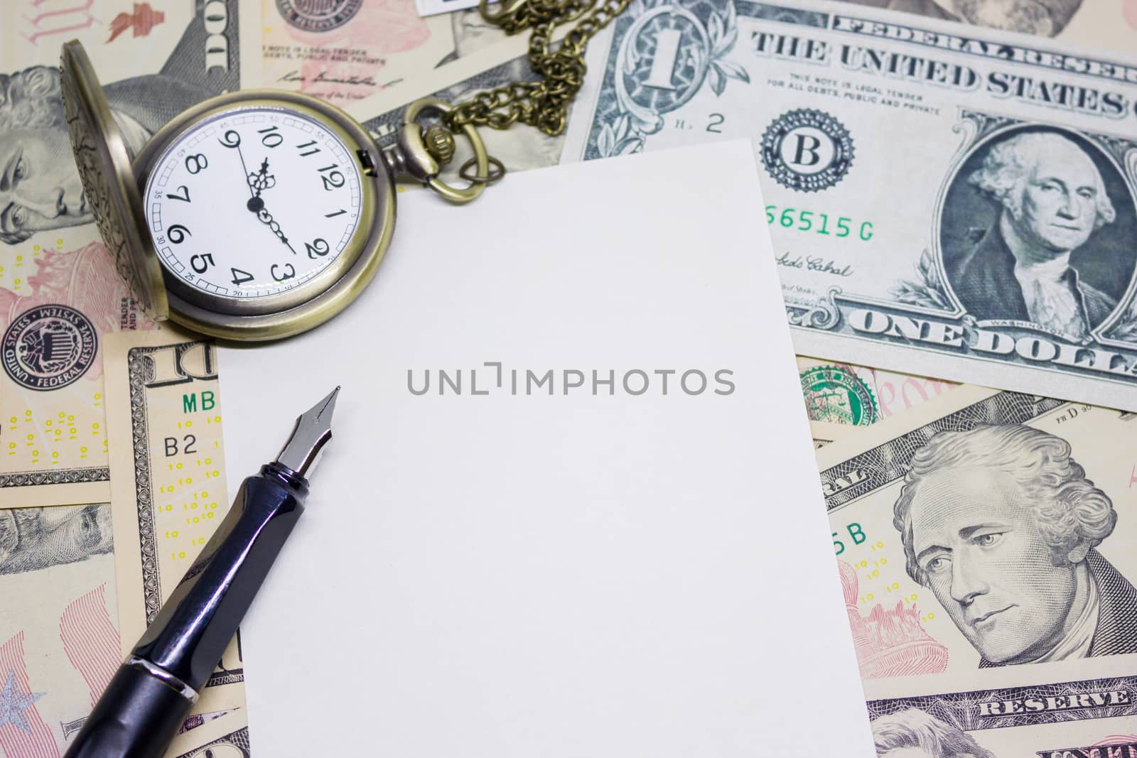 fountain pen, empty paper and classic pocket watch on dollar banknote, concept and idea of time value and money, business and finance concepts.