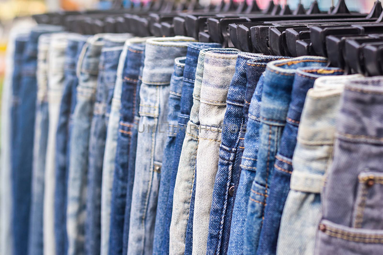 Lot of different blue jeans, selective focus