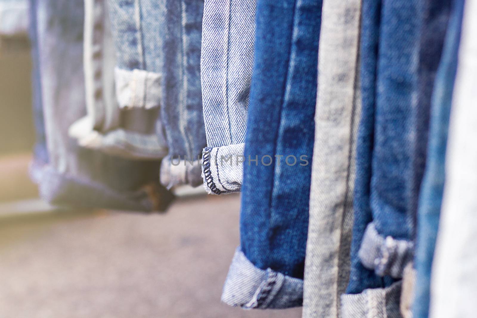 Lot of different blue jeans, selective focus