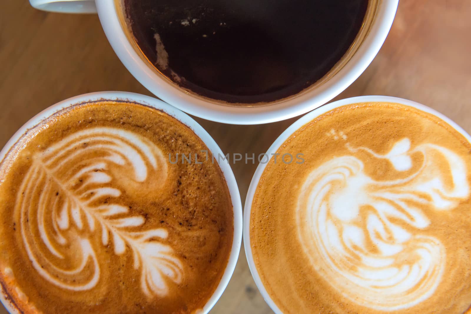 latte art coffee or cappuccino on wooden table background.