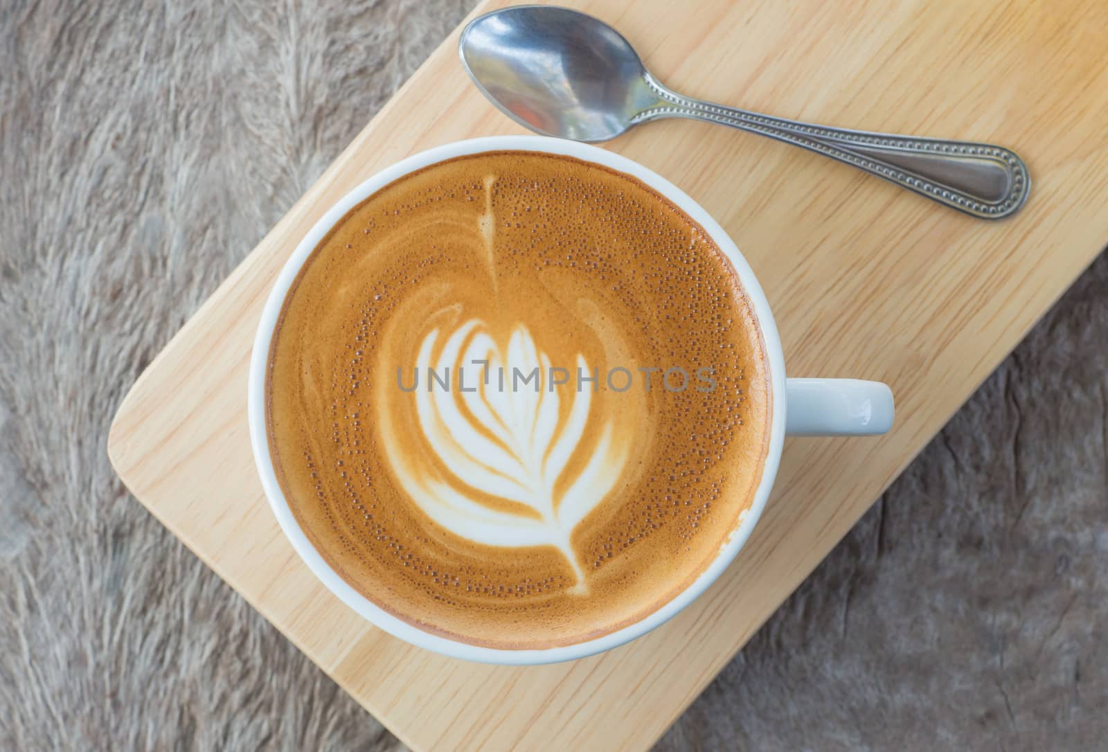 latte art coffee or cappuccino on wooden table background.