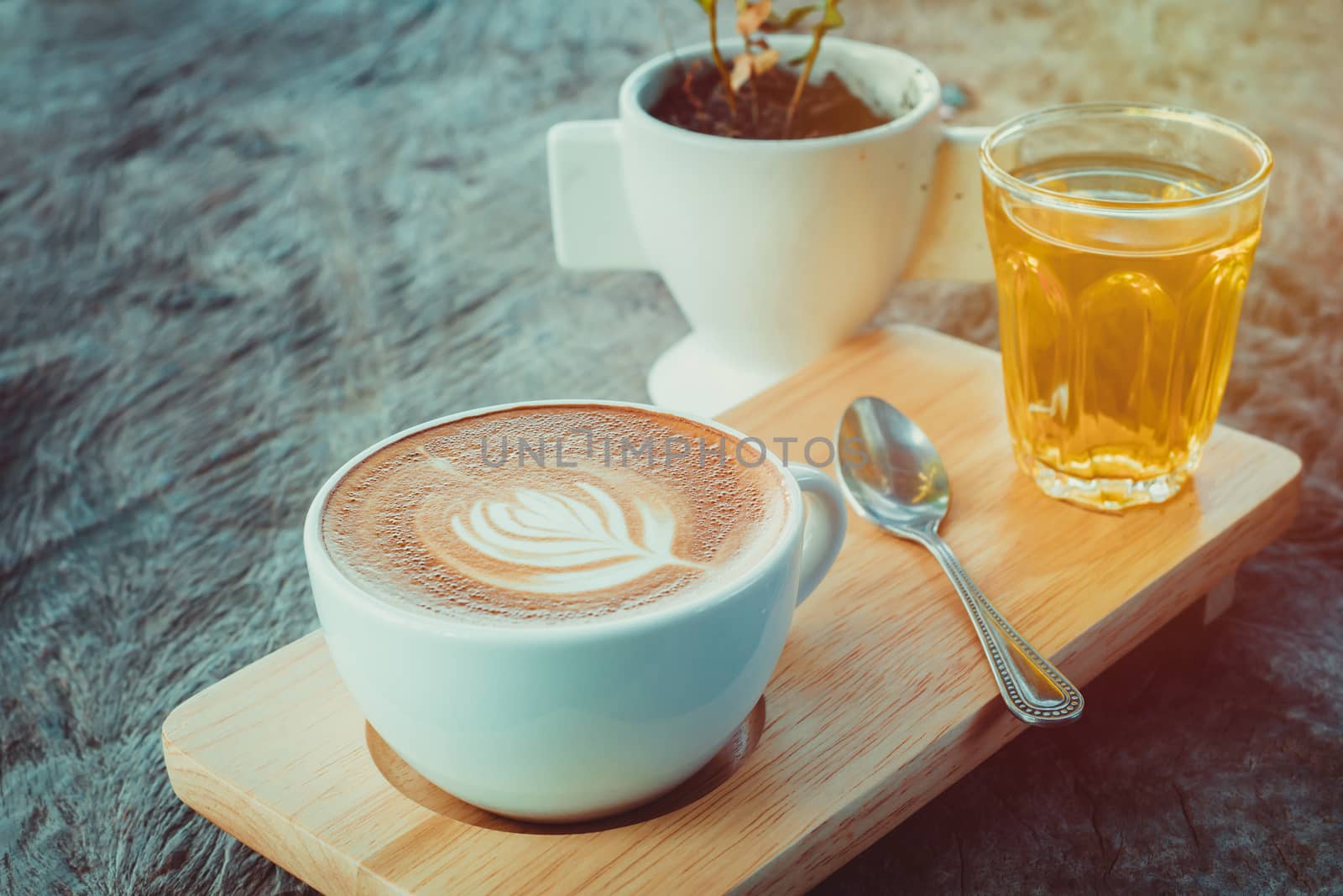 latte art coffee or cappuccino on wooden table background.