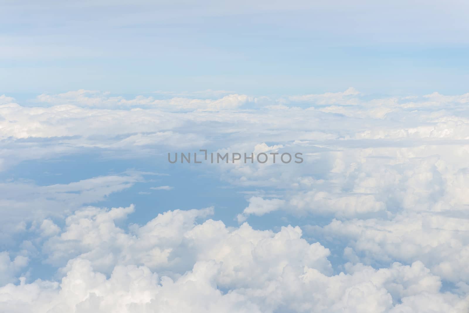 Blue sky and Clouds as seen through window of aircraft.