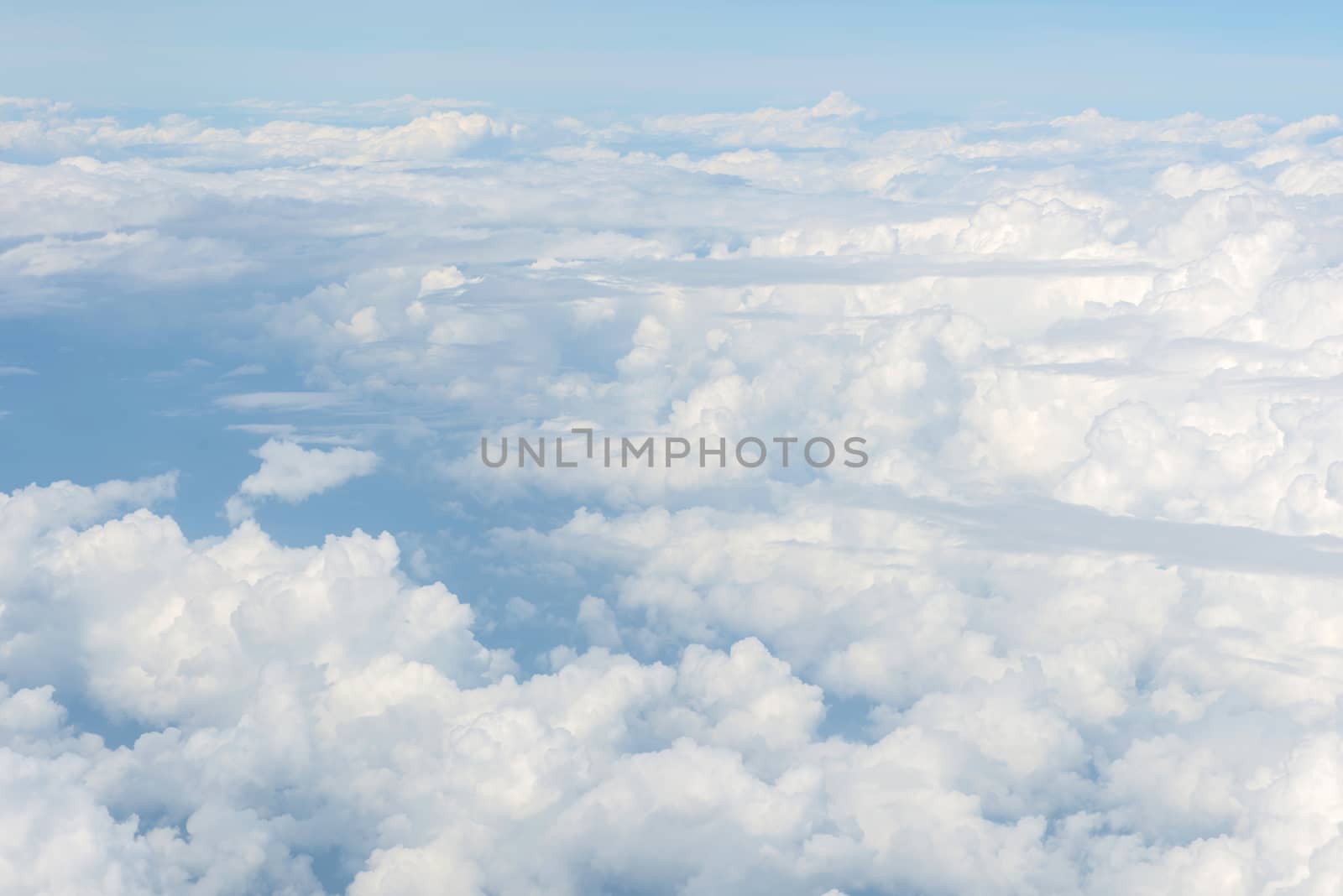 Blue sky and Clouds as seen through window of aircraft.