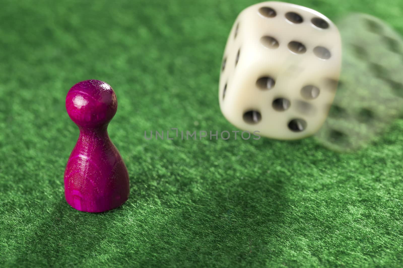 Pawn and a dice in motion for playing games