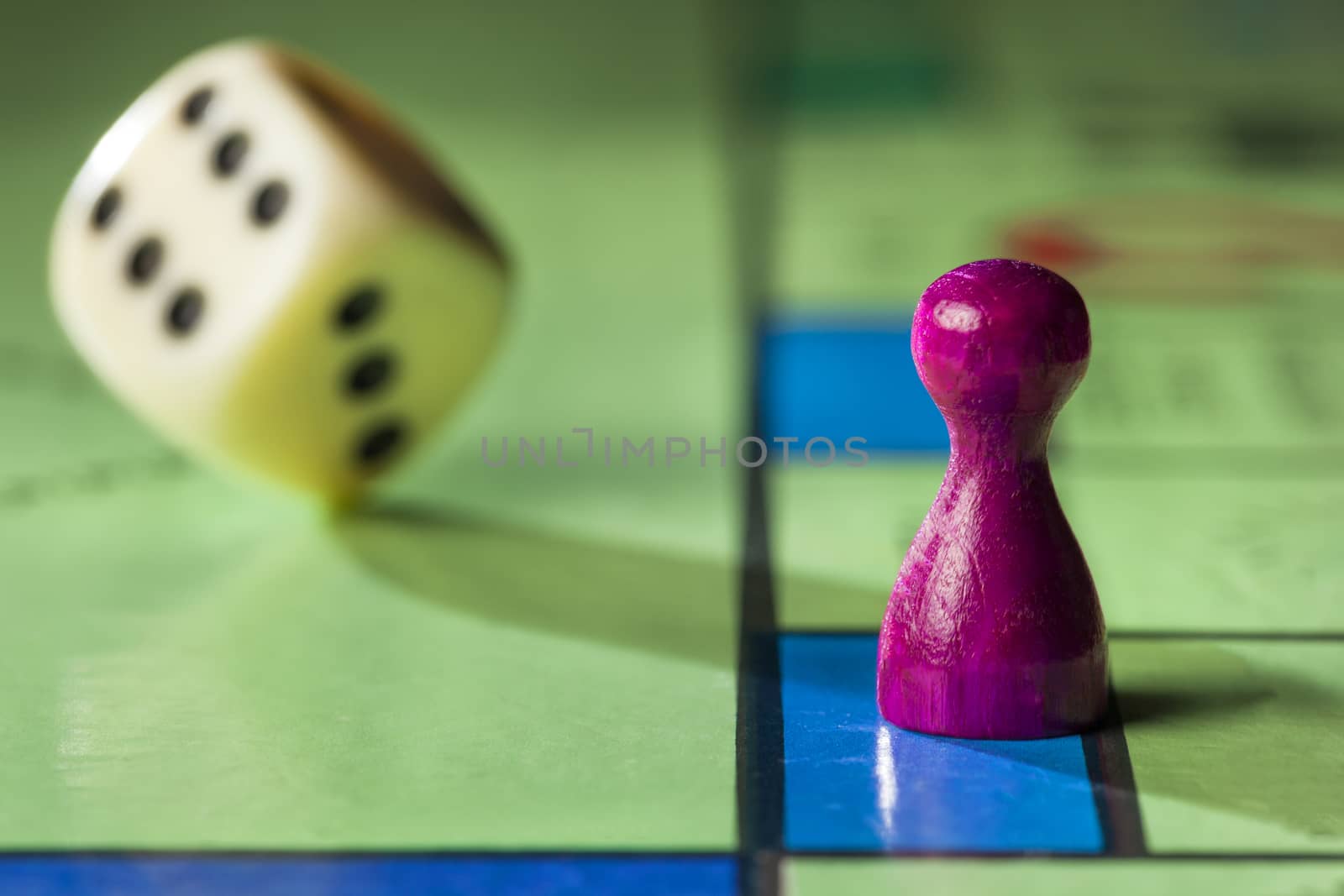 Close up of a board game with pawn and  rolling dice