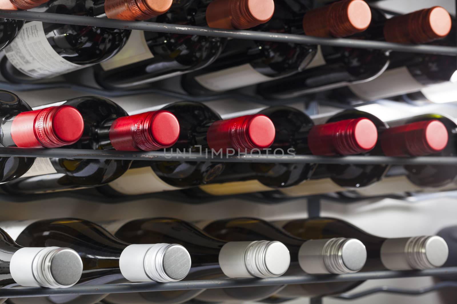 Quality wine bottles with screw caps in a wine rack by kievith