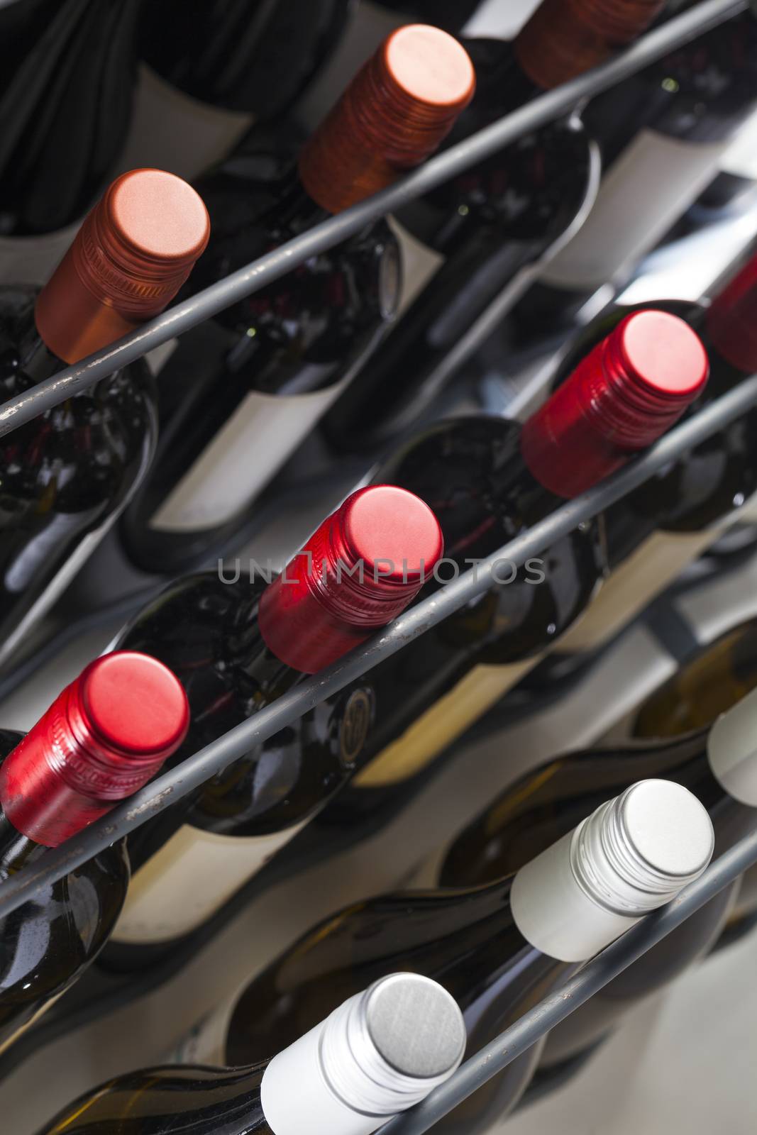 Quality wine bottles with screw caps in a wine rack by kievith
