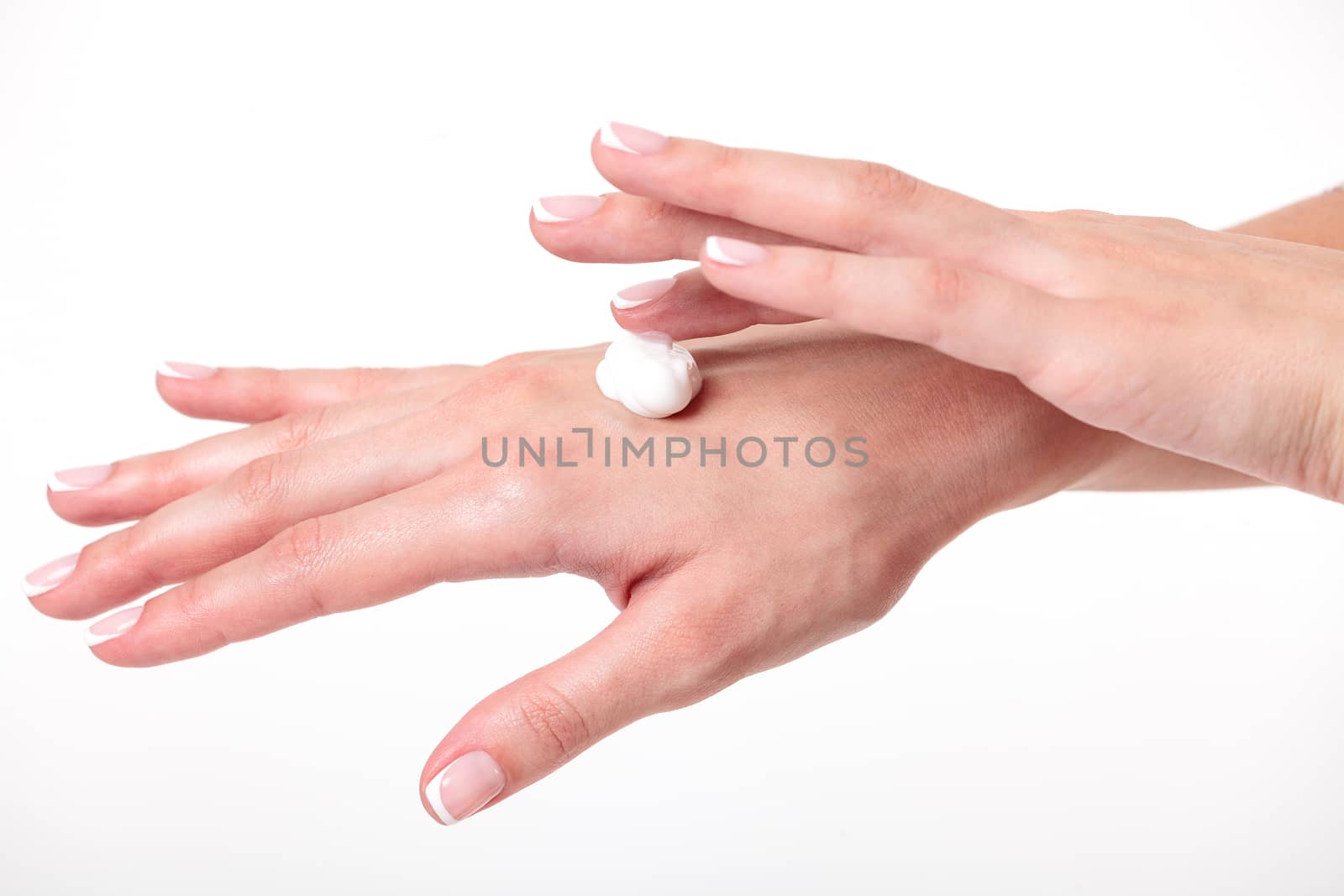 Closeup shot of beautiful woman's hands with cream, white background