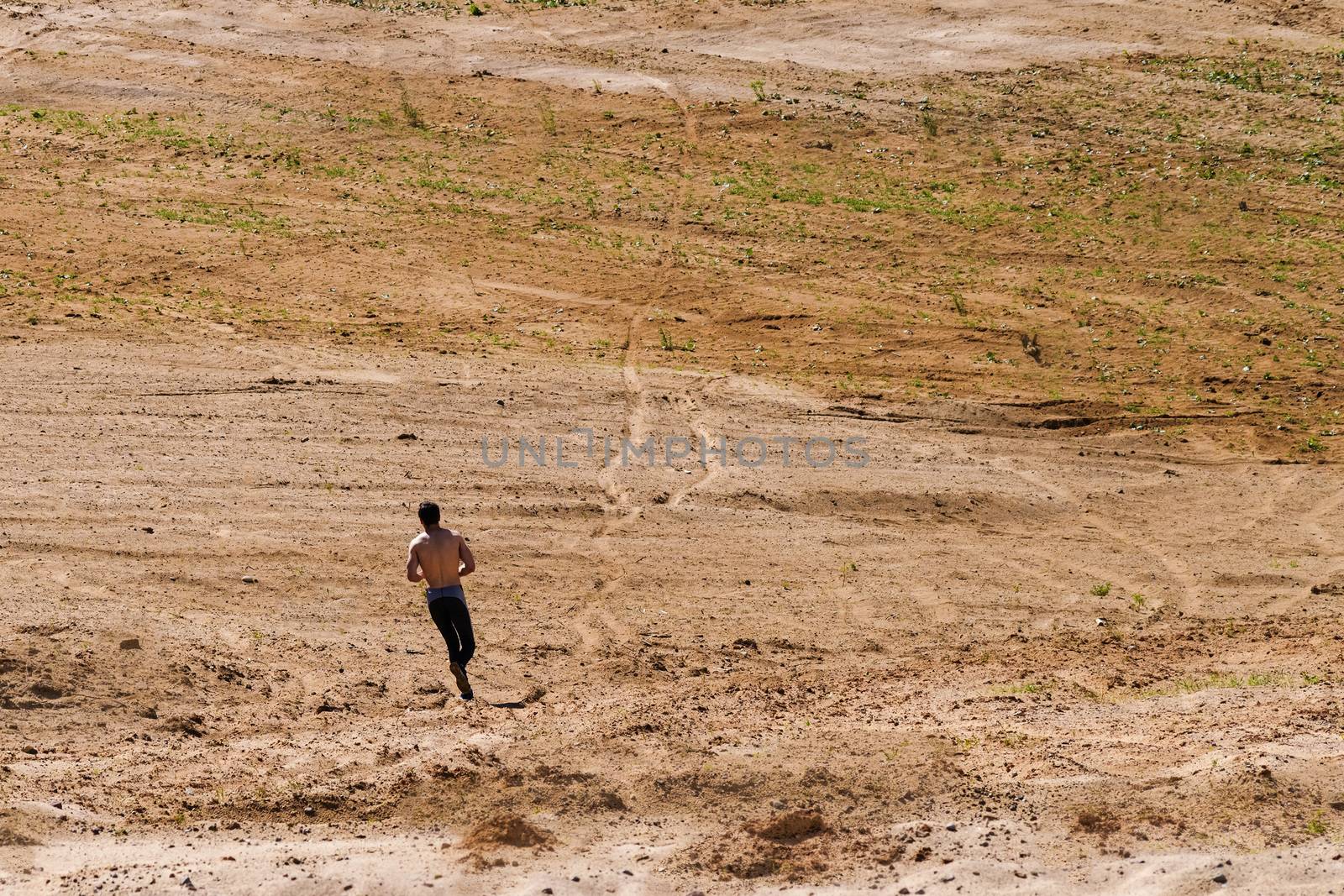 Young man running in the desert