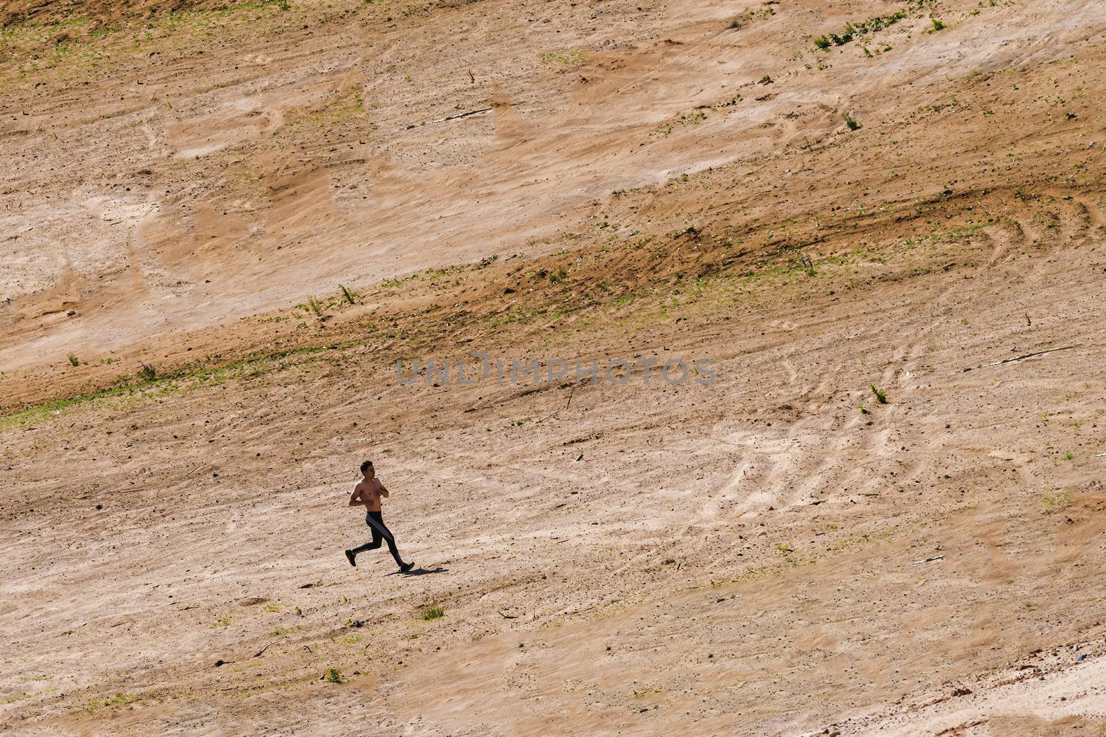 Young man running in the desert