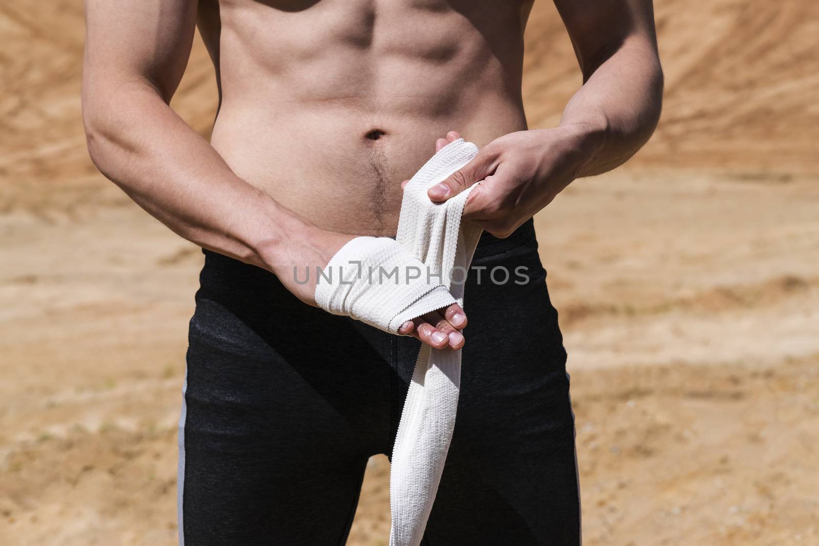 A young man goes in for sports on the sand