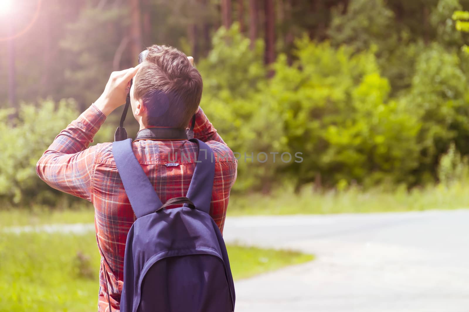 A young man takes photos of nature. Summer-Autumn.