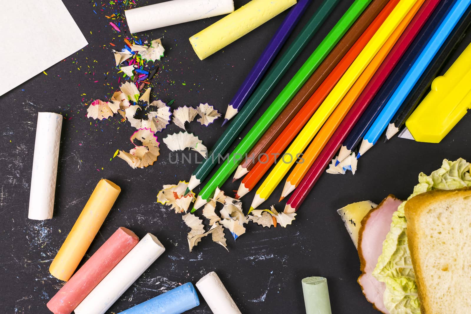 Sandwich, crayons, pencils. School lunch. A school break.