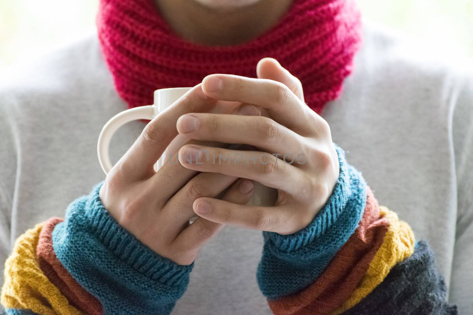 A young man holding a Cup of tea and lemon. Cold, cold, disease.