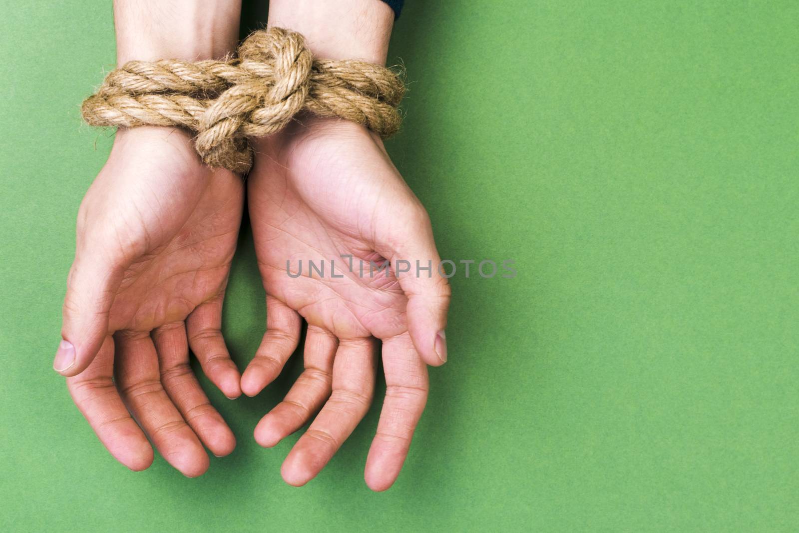 The man with the connected hands against a green background
