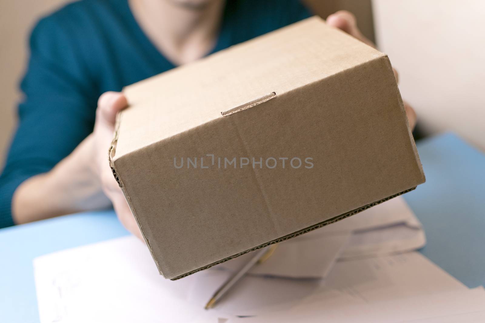 The man gives a parcel to the post office. Mail.