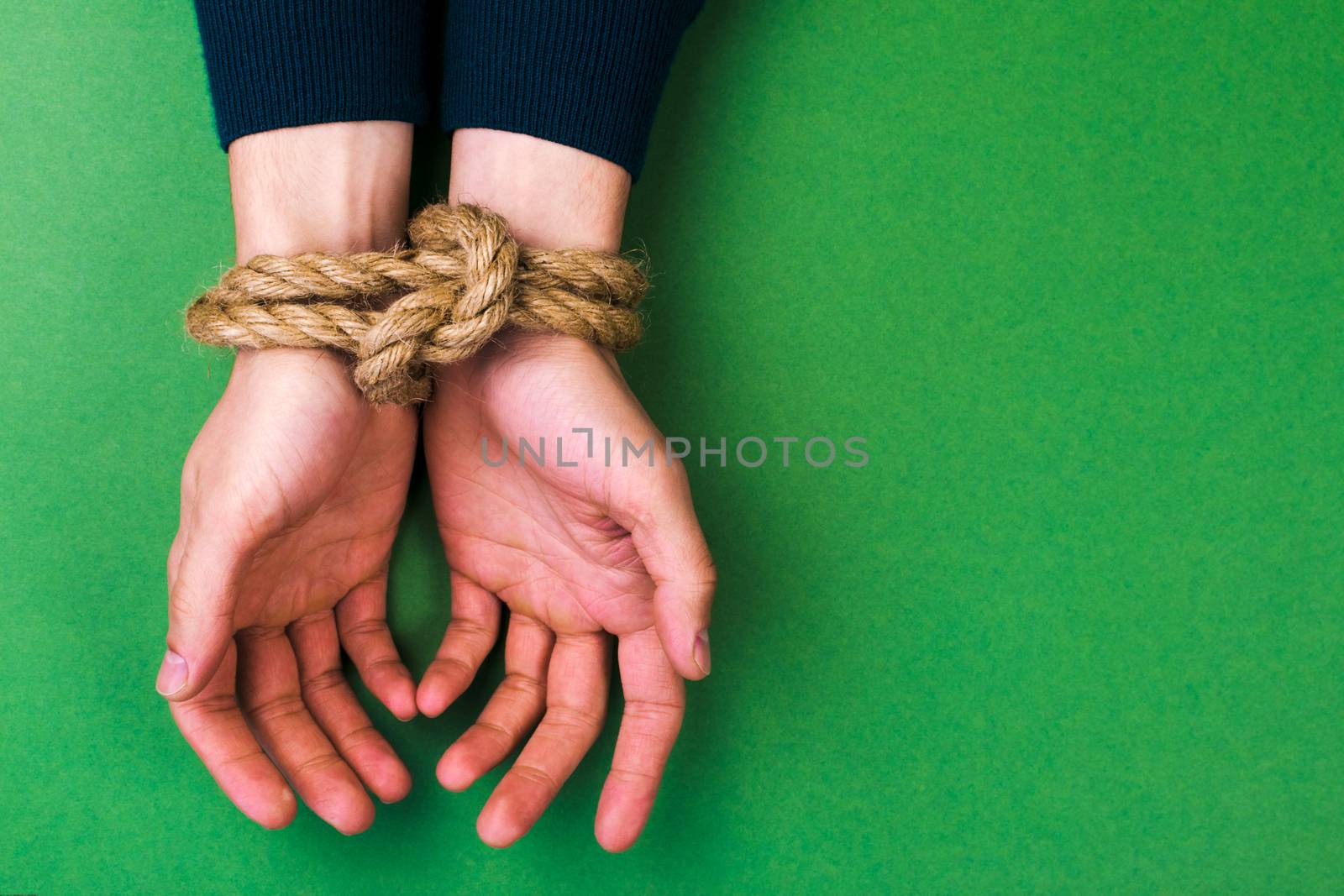 The man with the connected hands against a green background