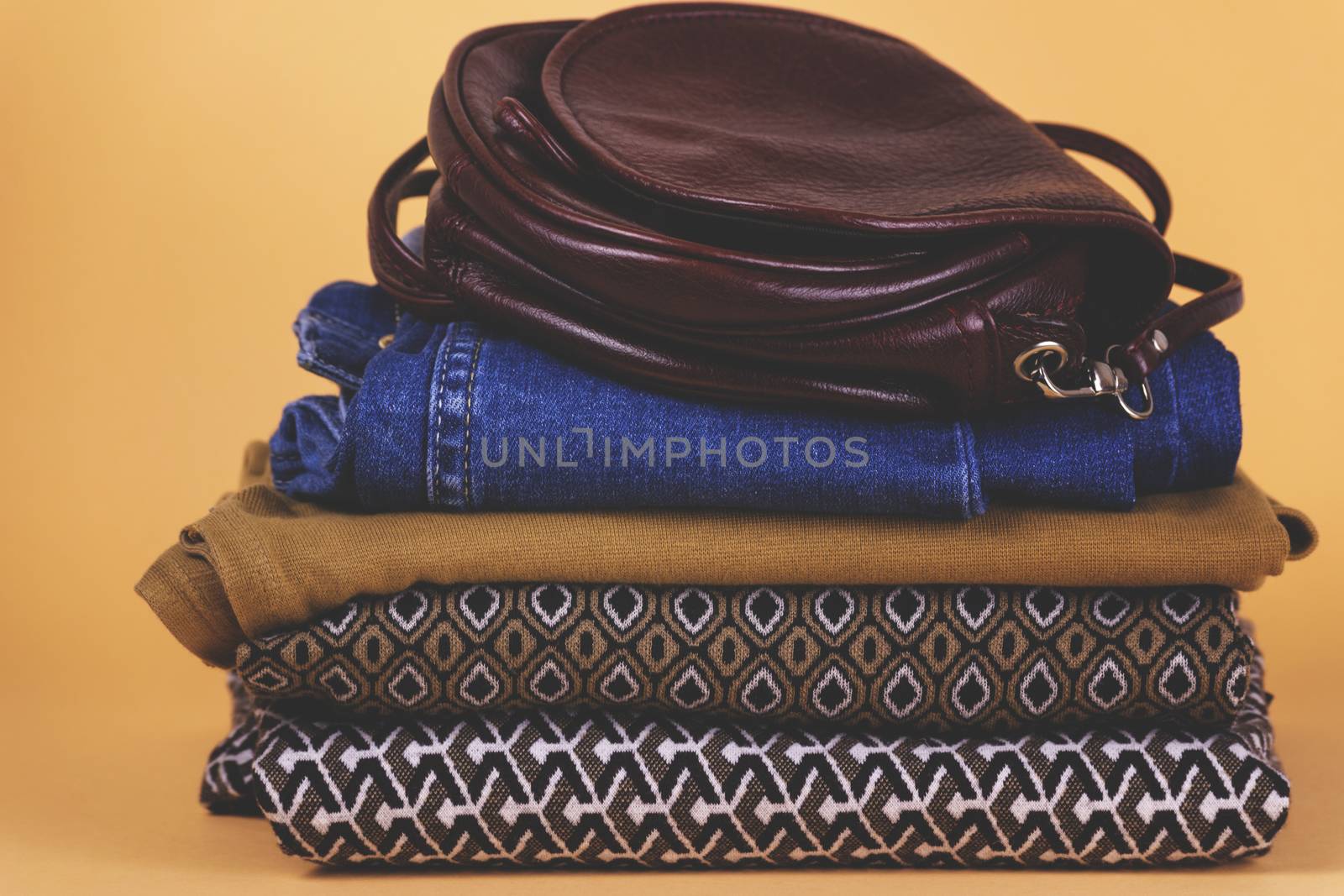 Women's shoes, clothing and accessories on a colored background