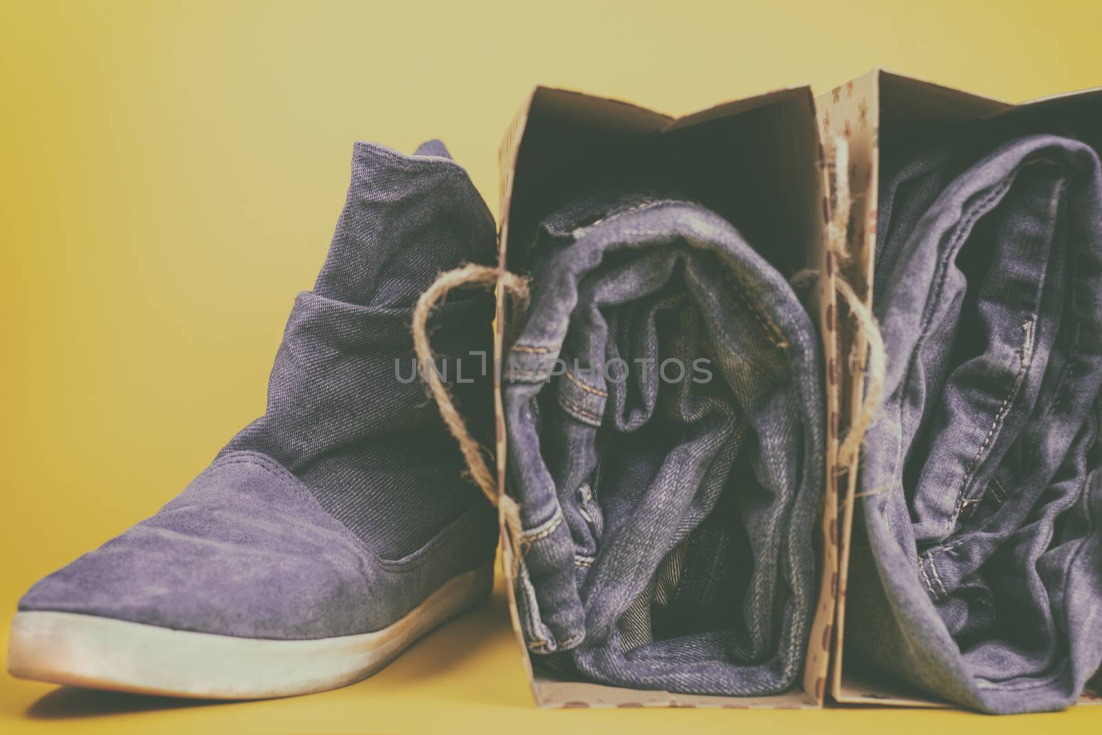 Denim clothes and shoes on a colored background. Vintage.