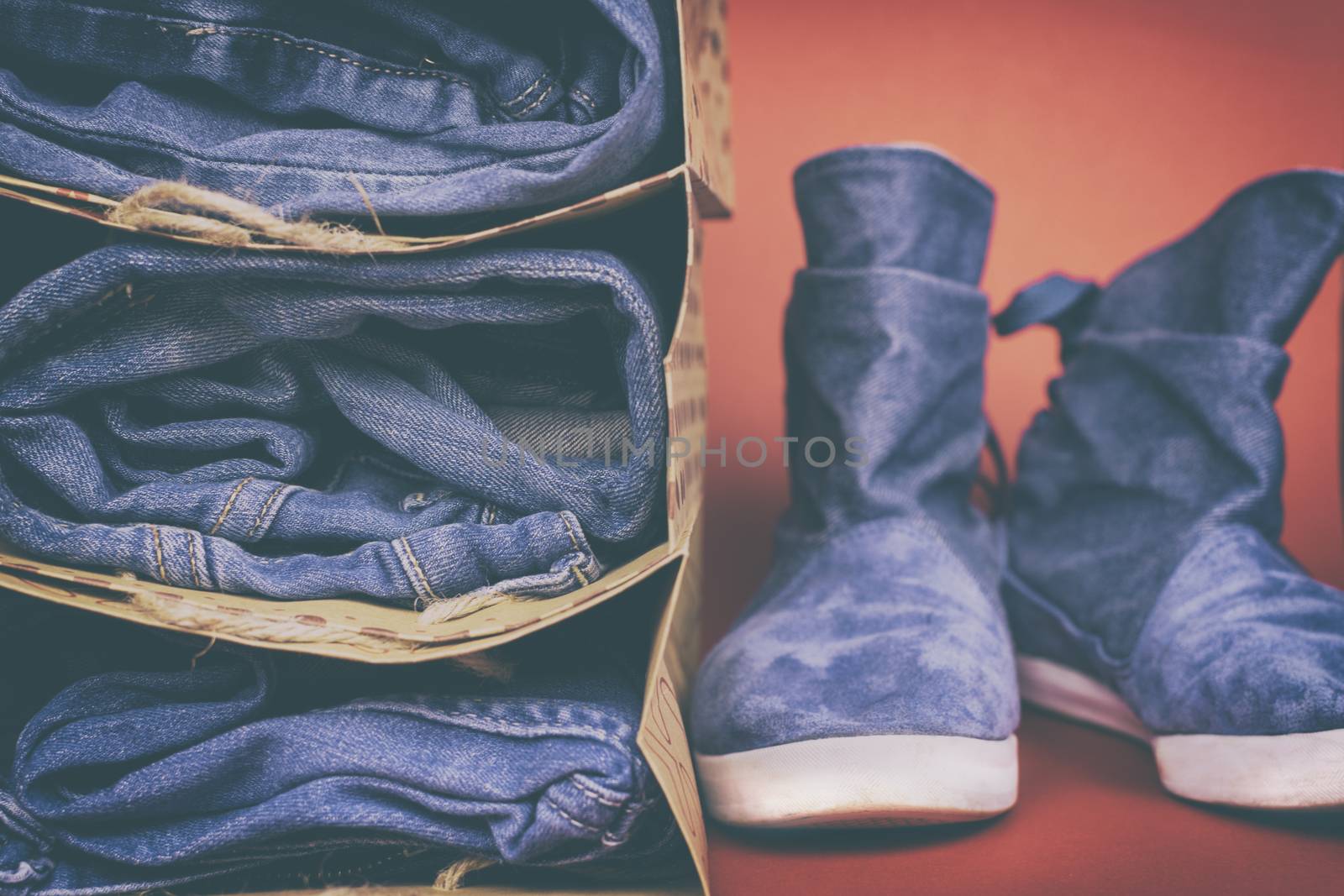 Denim clothes and shoes on a colored background. Vintage.