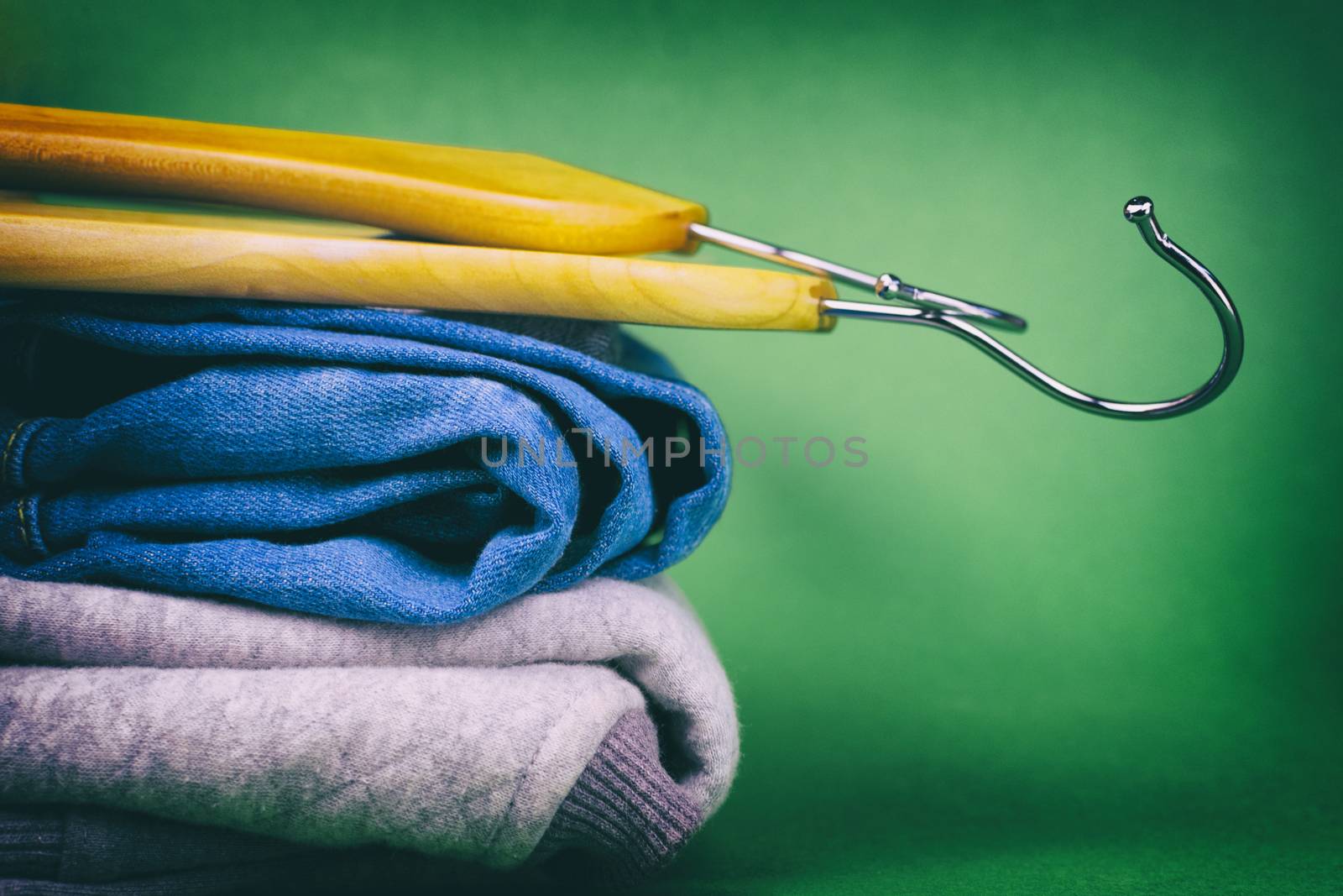 Hangers and denim on a colored background. Made in a vintage performance.