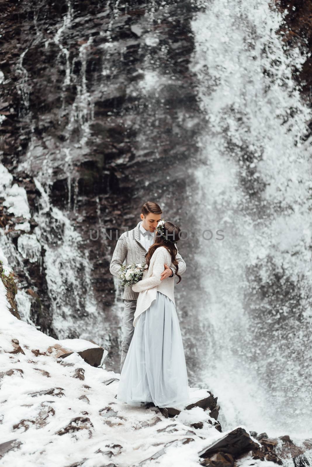 bride and groom on the mountain waterfall by Andreua