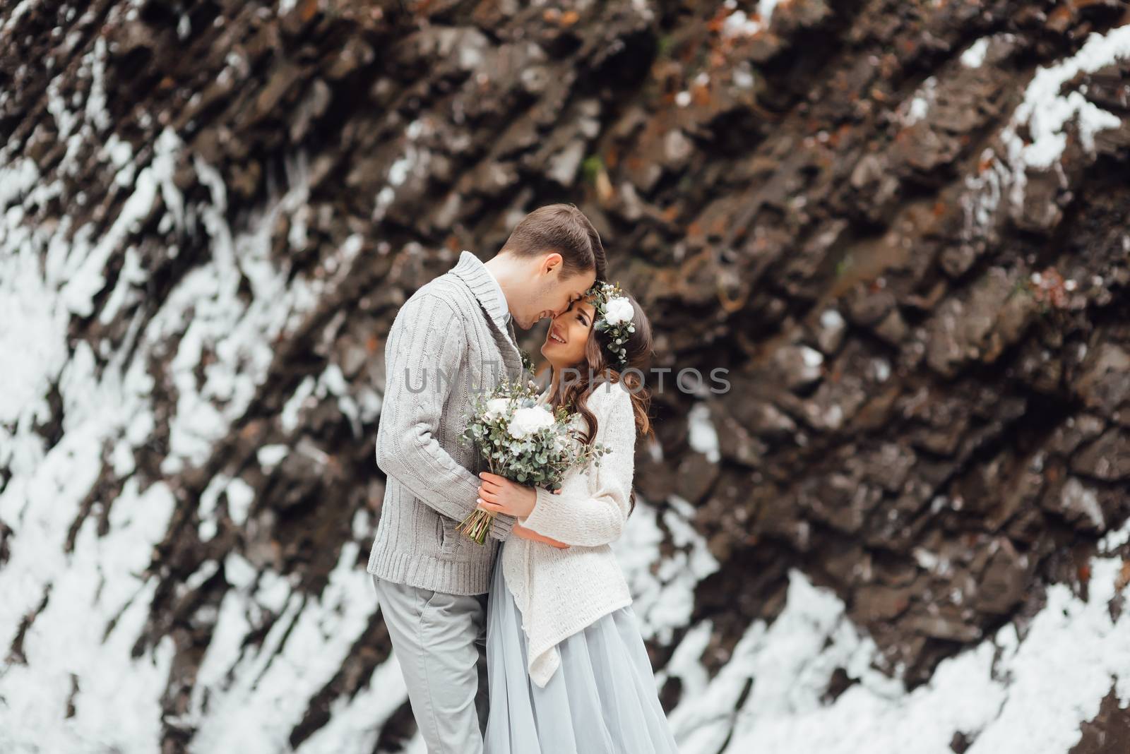 bride and groom on the background of a mountain waterfall