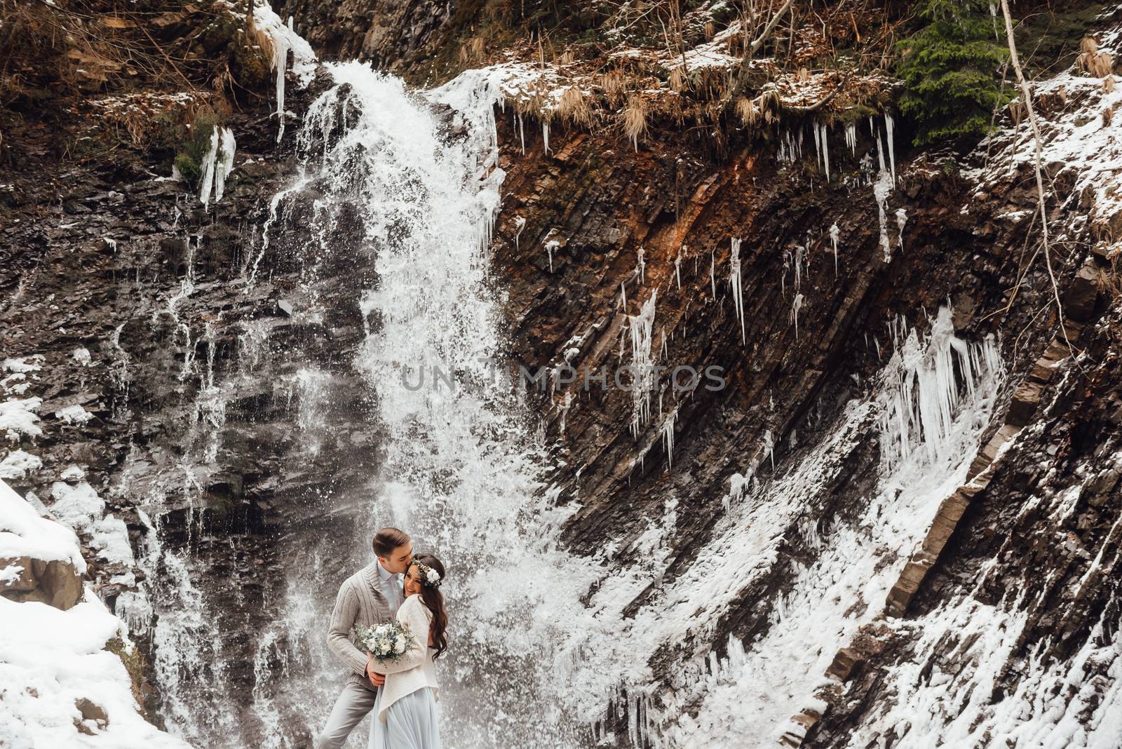 bride and groom on the mountain waterfall by Andreua