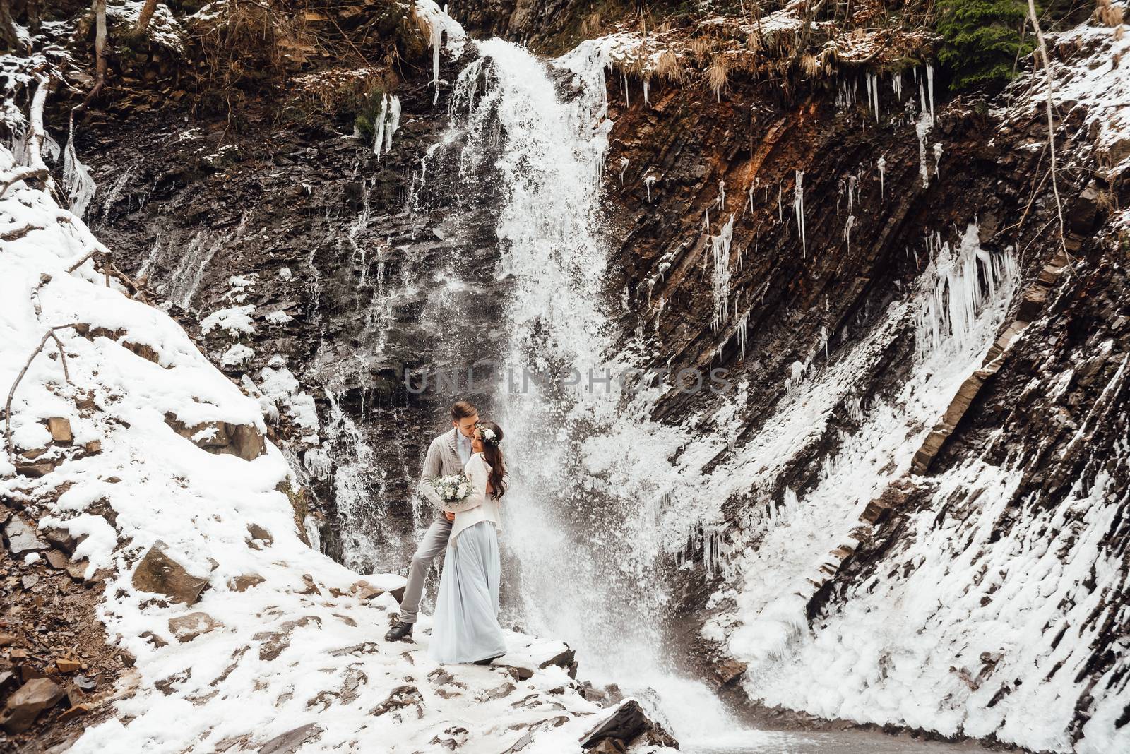 bride and groom on the mountain waterfall by Andreua