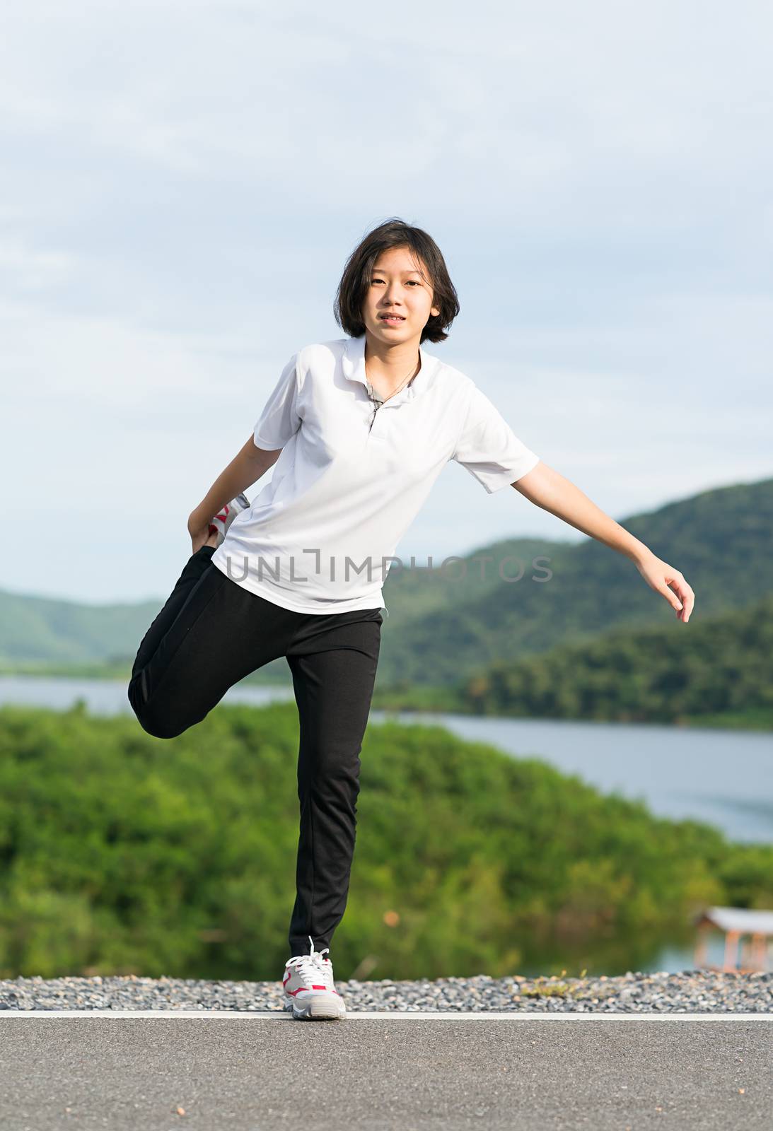 Woman doing exercising and warm up outdoor by stoonn