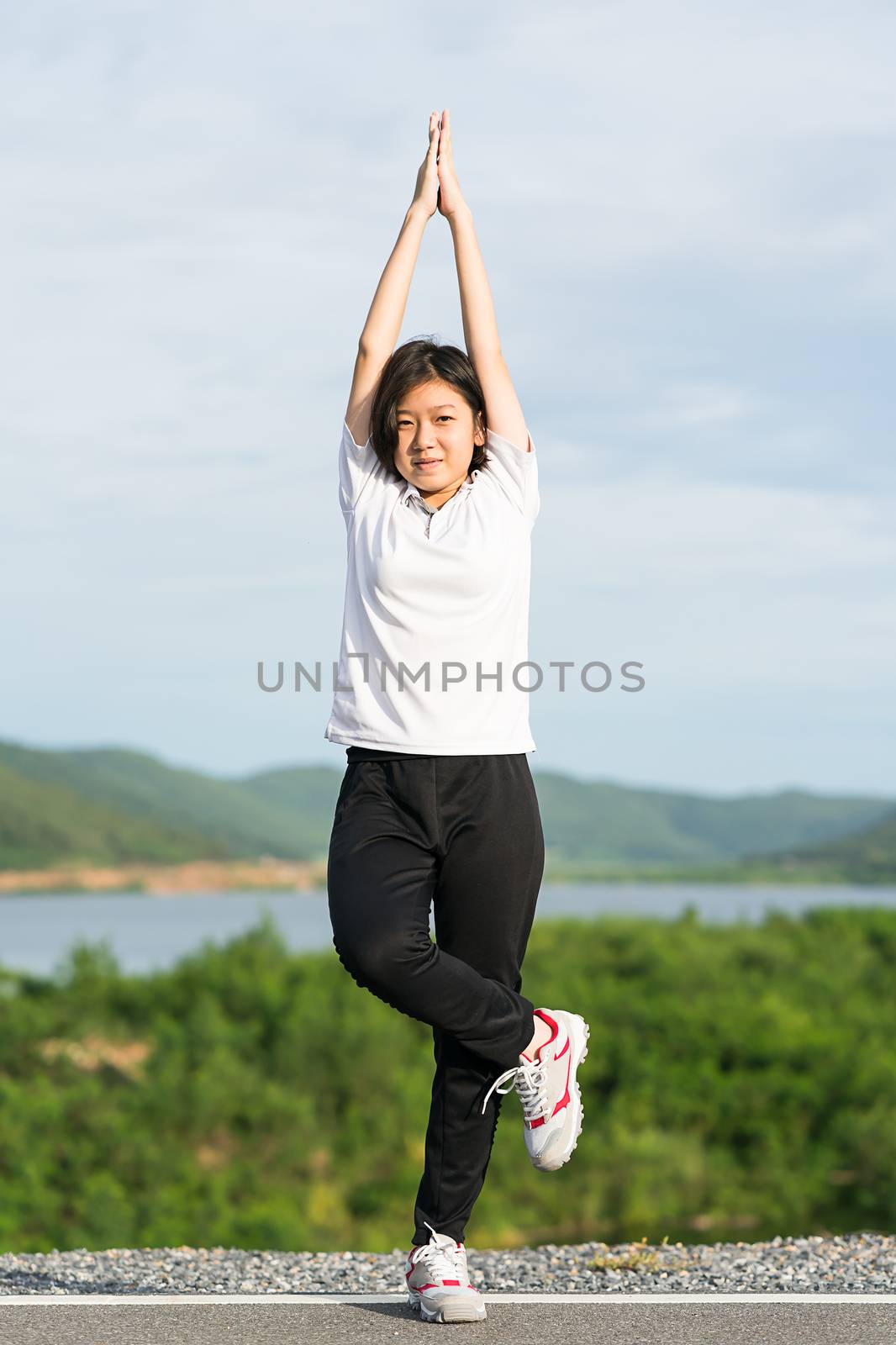 Woman doing exercising and warm up outdoor by stoonn