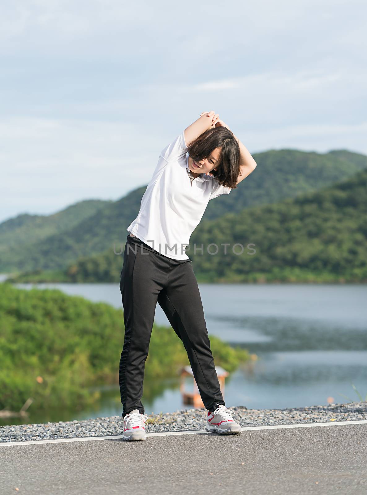 Woman short hair doing exercising outdoor by stoonn