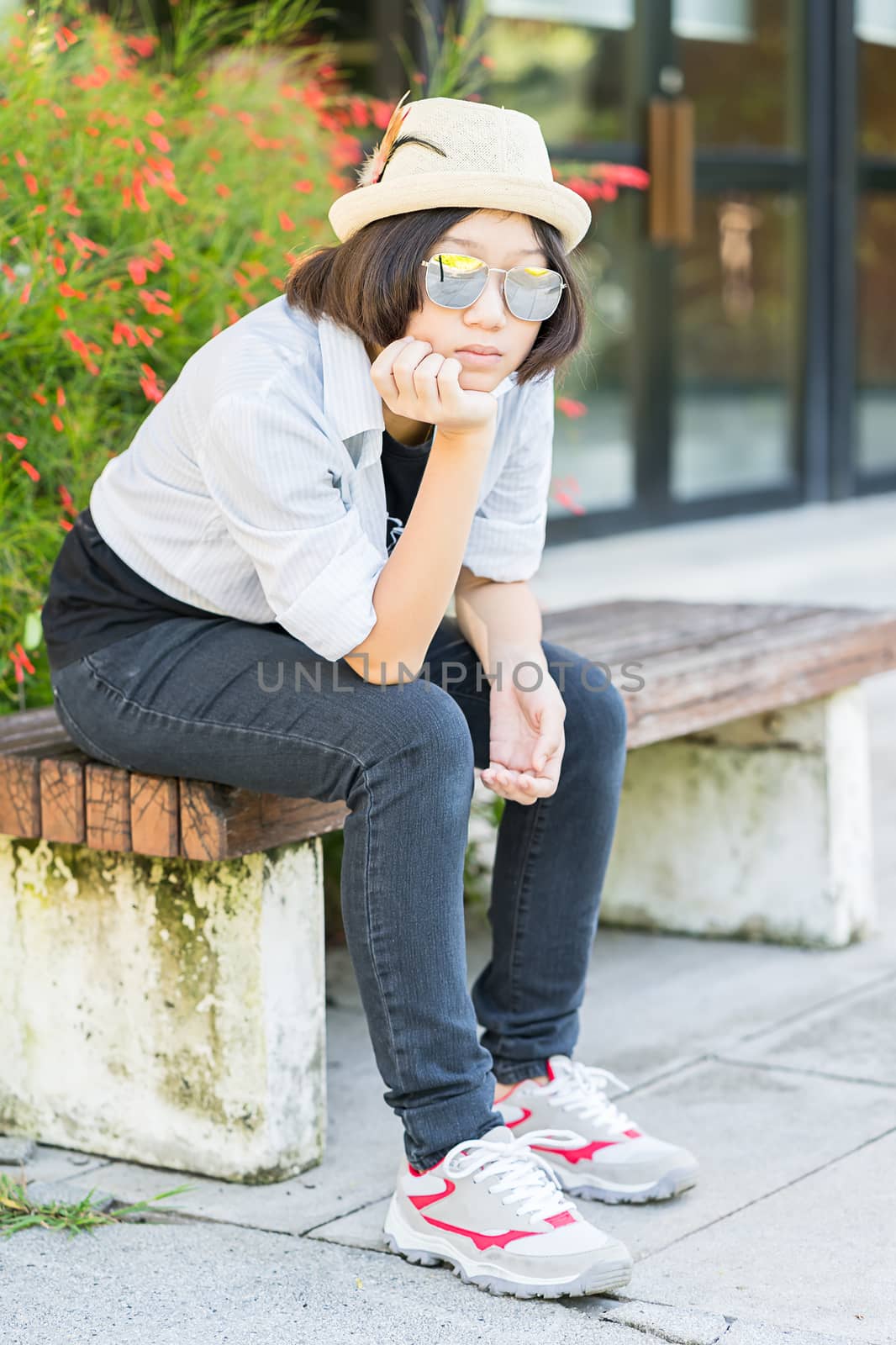 Women with short hair wearing hat in park by stoonn