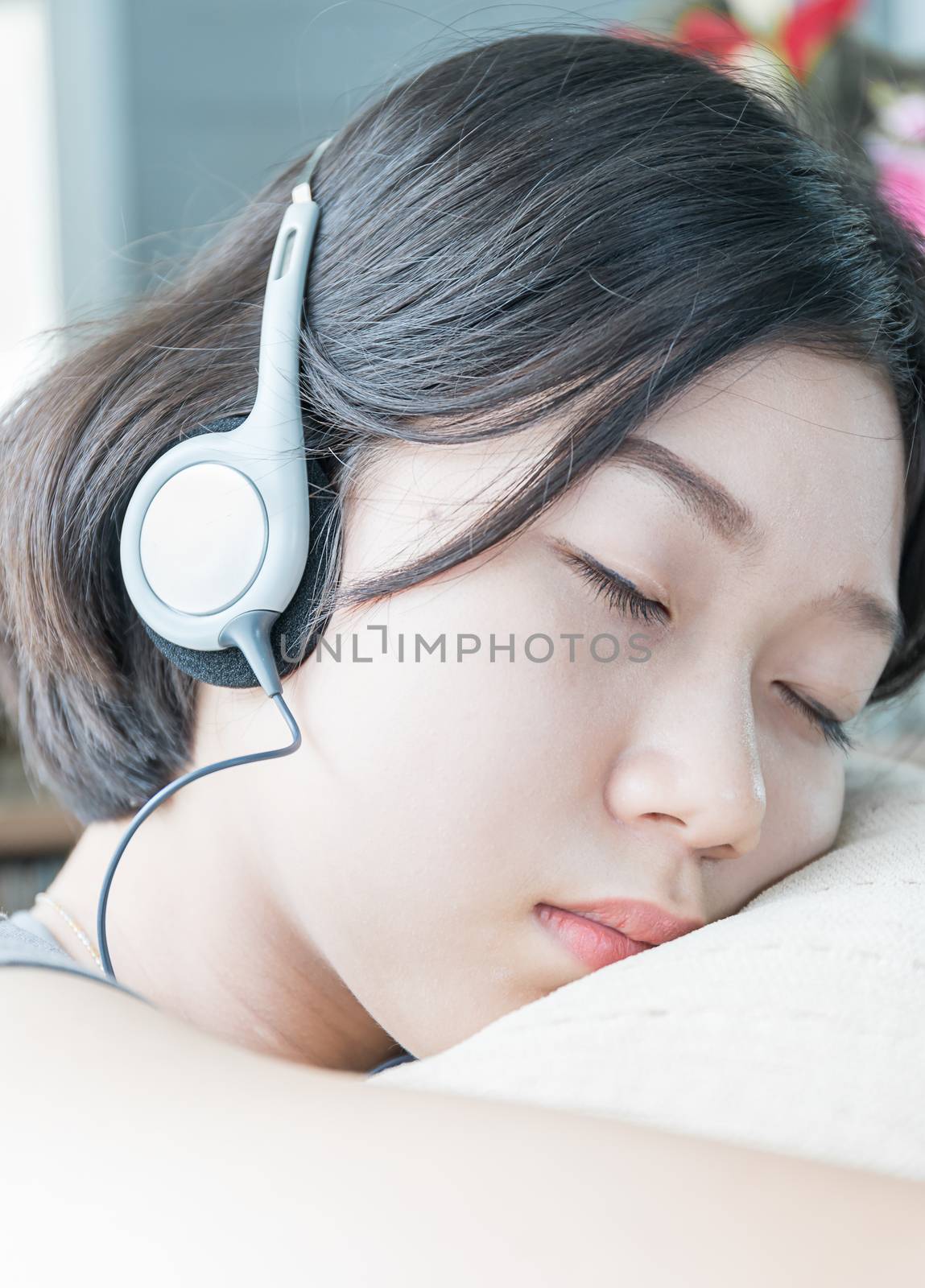 Young asian woman short hair listening music  by stoonn