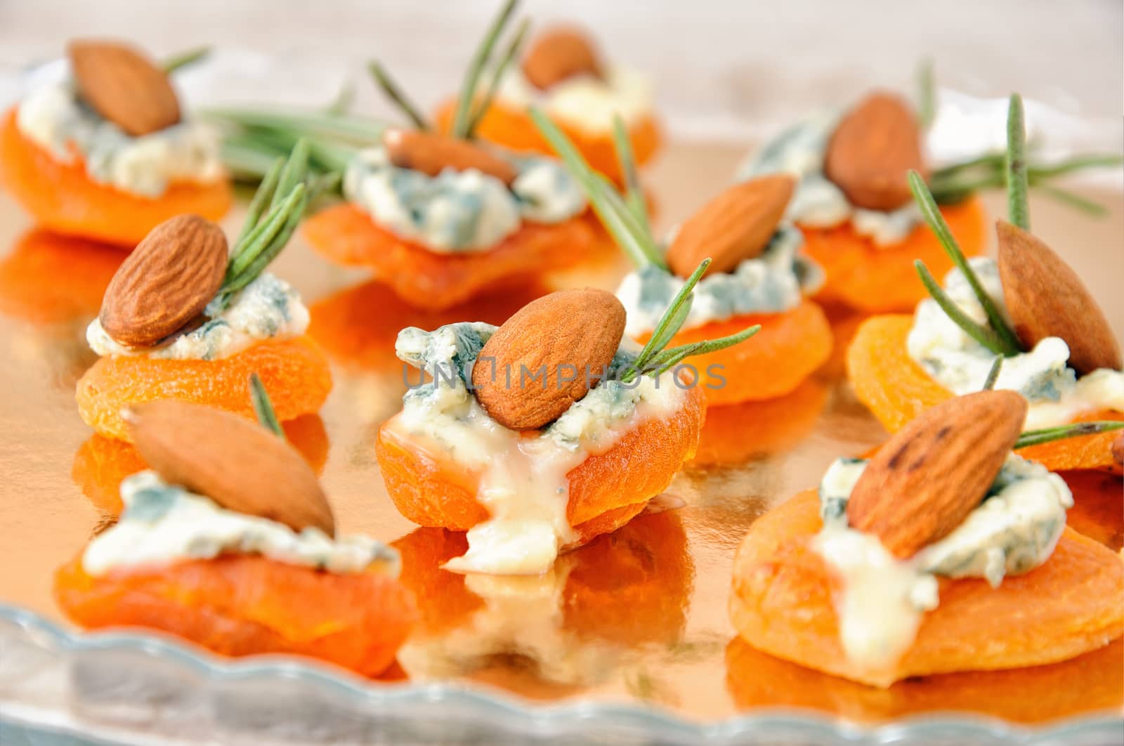 Cocktail snack from dried apricots with gorgonzola and almonds
