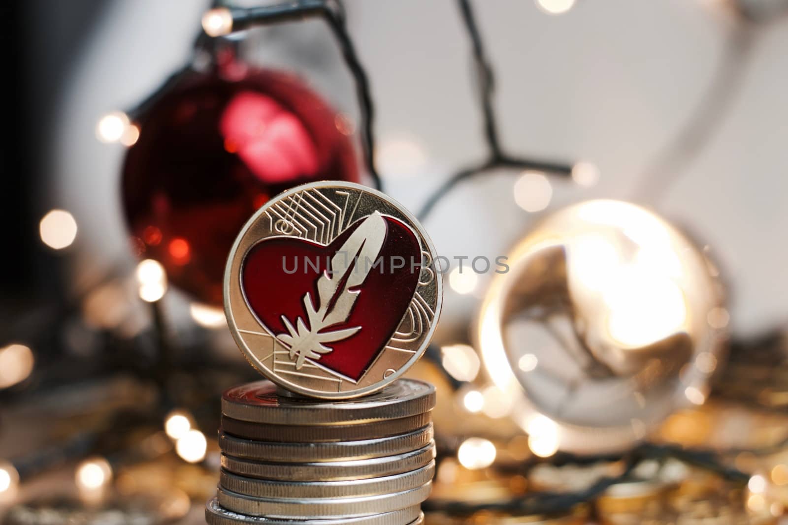 Digital currency physical metal gold feather coin. Christmas crypto currency concept.